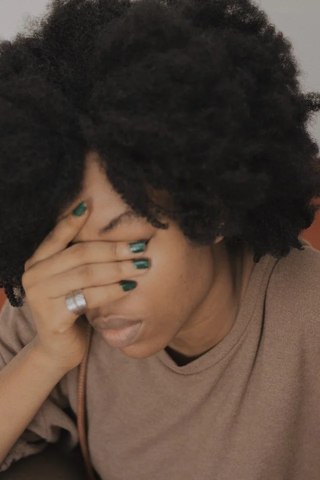 woman with hand over her eyes