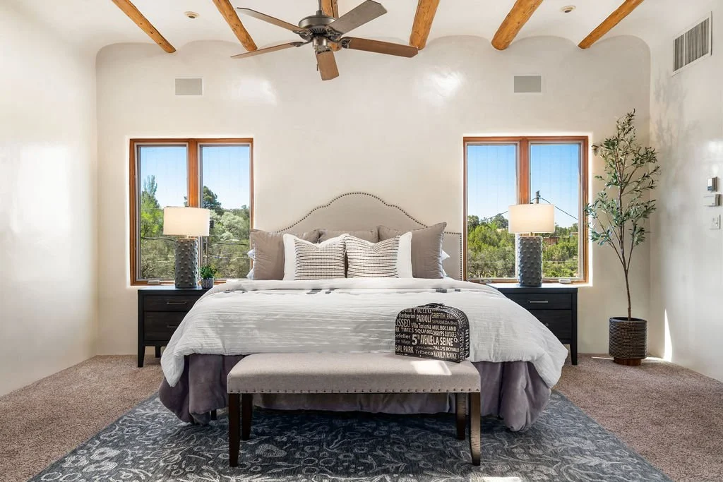 primary bedroom vigas Santa Fe real estate staging throw pillows headboard bench