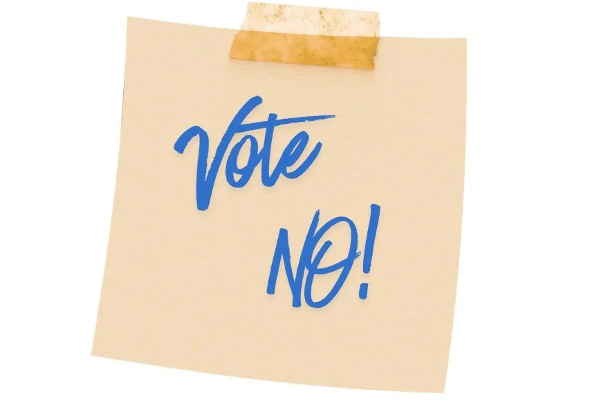 orange sticky note with Vote NO! on it