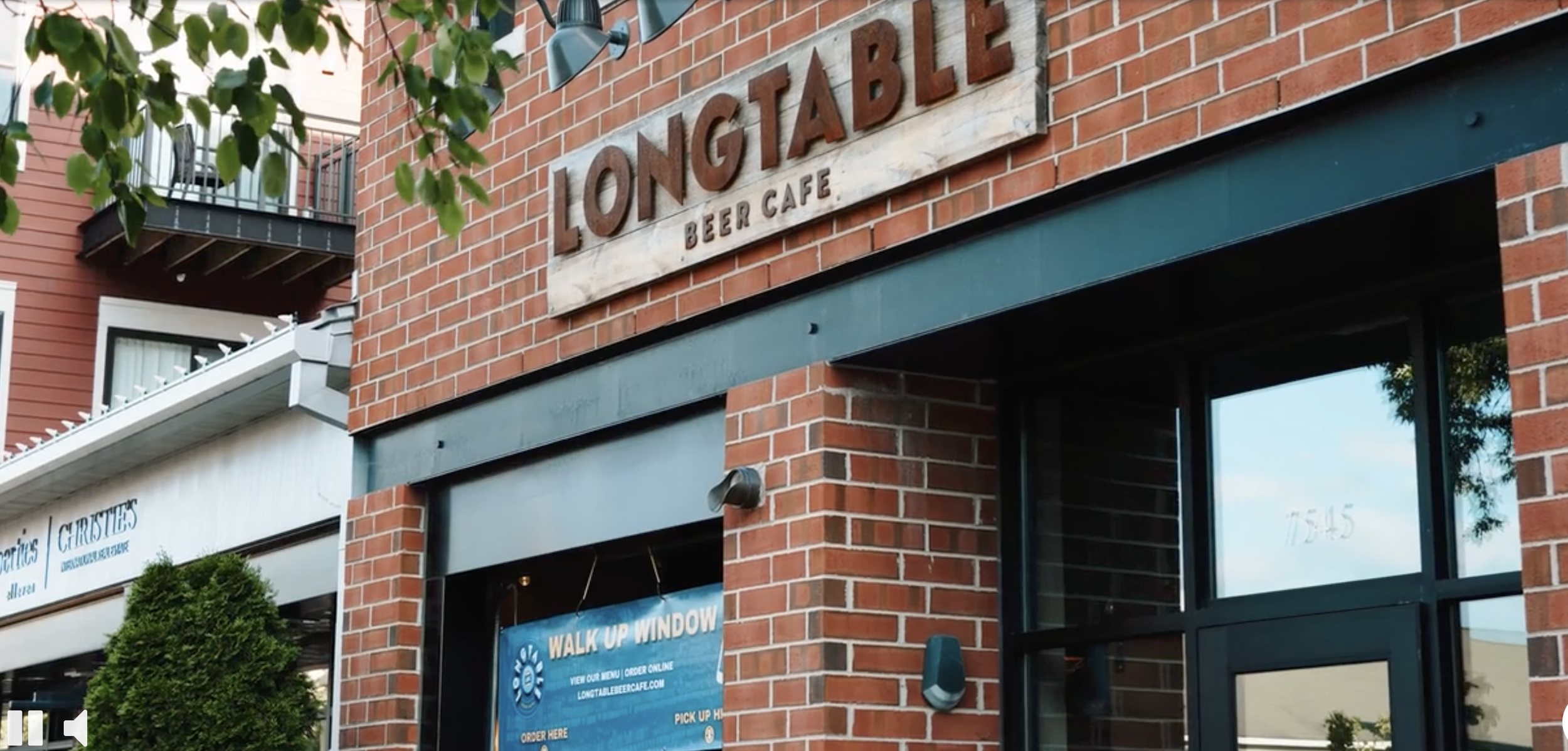 Brick building with sign: Longtable Beer Cafe 