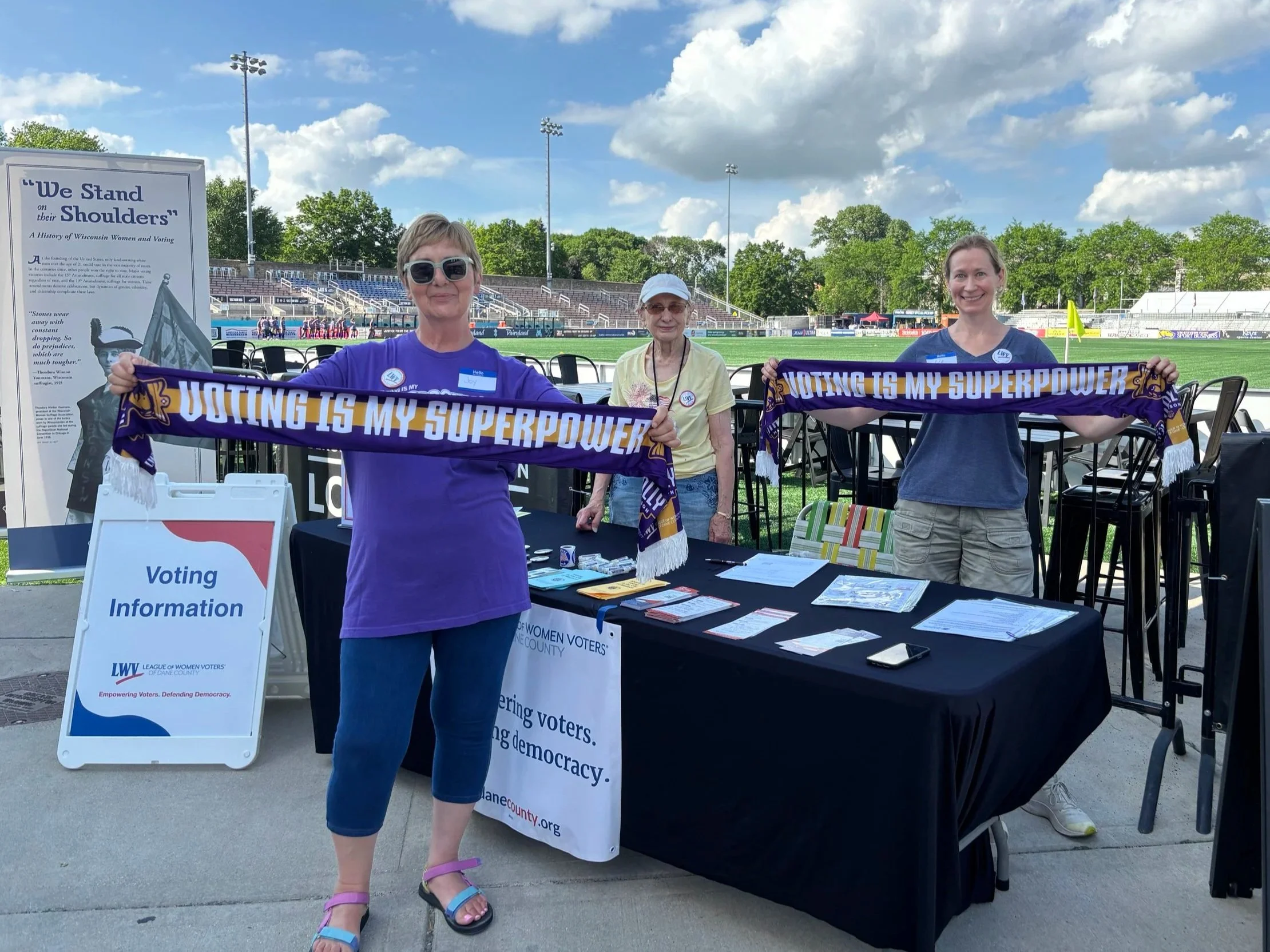 Joy Cardin, Shirley Haidinger, &  Elizabeth Pleuss at our outreach table with Voting scarves