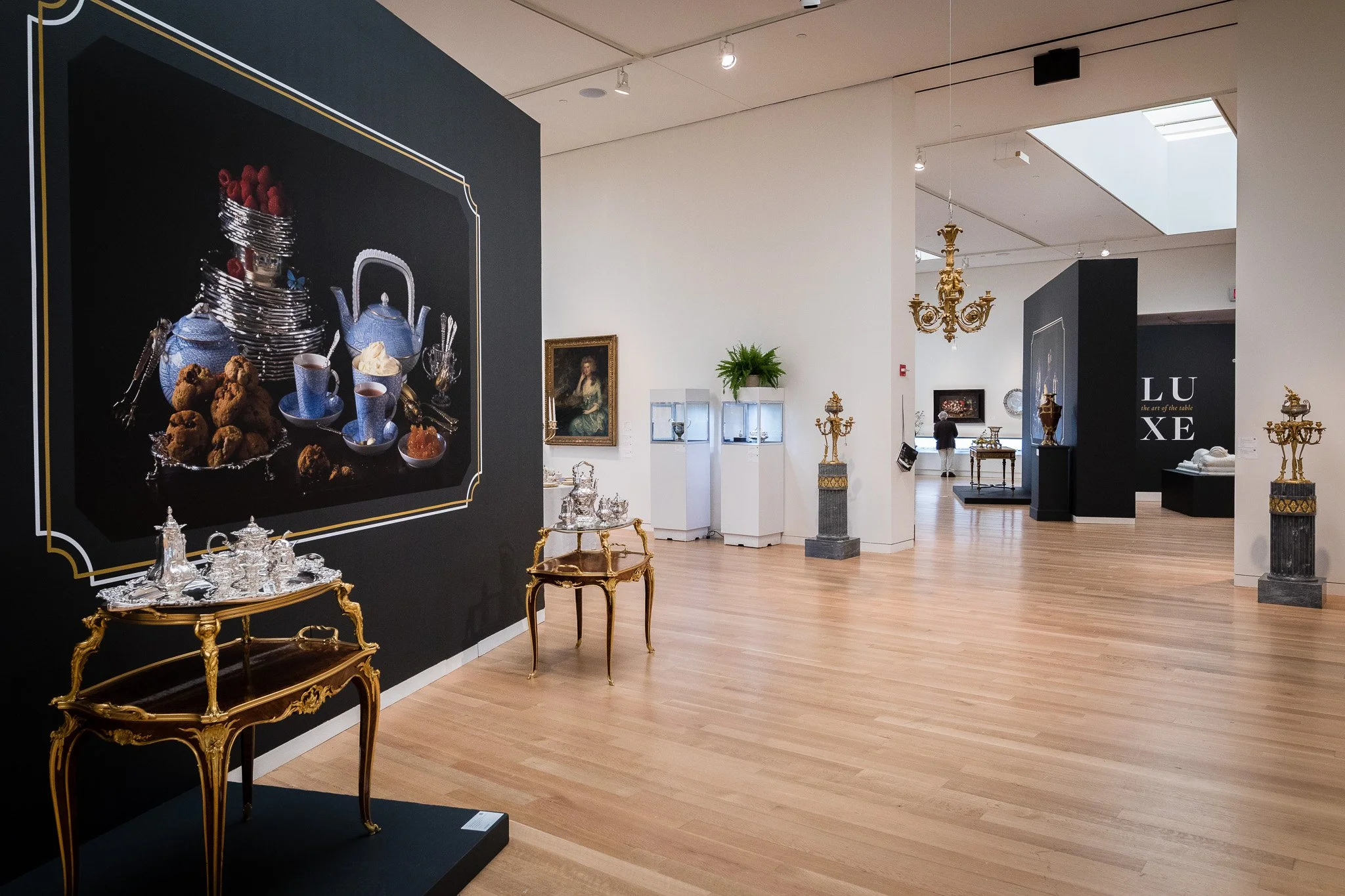 Paulette Tavormina for Sotheby’s — Still life from LUXE: The Art of the Table, featuring silver tea sets and gilded furniture in her signature Old Master style, photographed in Sotheby’s 10th floor gallery.