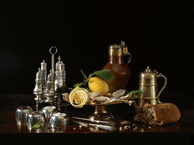 Paulette Tavormina for Sotheby’s — From LUXE: The Art of the Table, a still life in her Old Master style with lemon, honey jar, bread, silverware, and antique silver works of art.