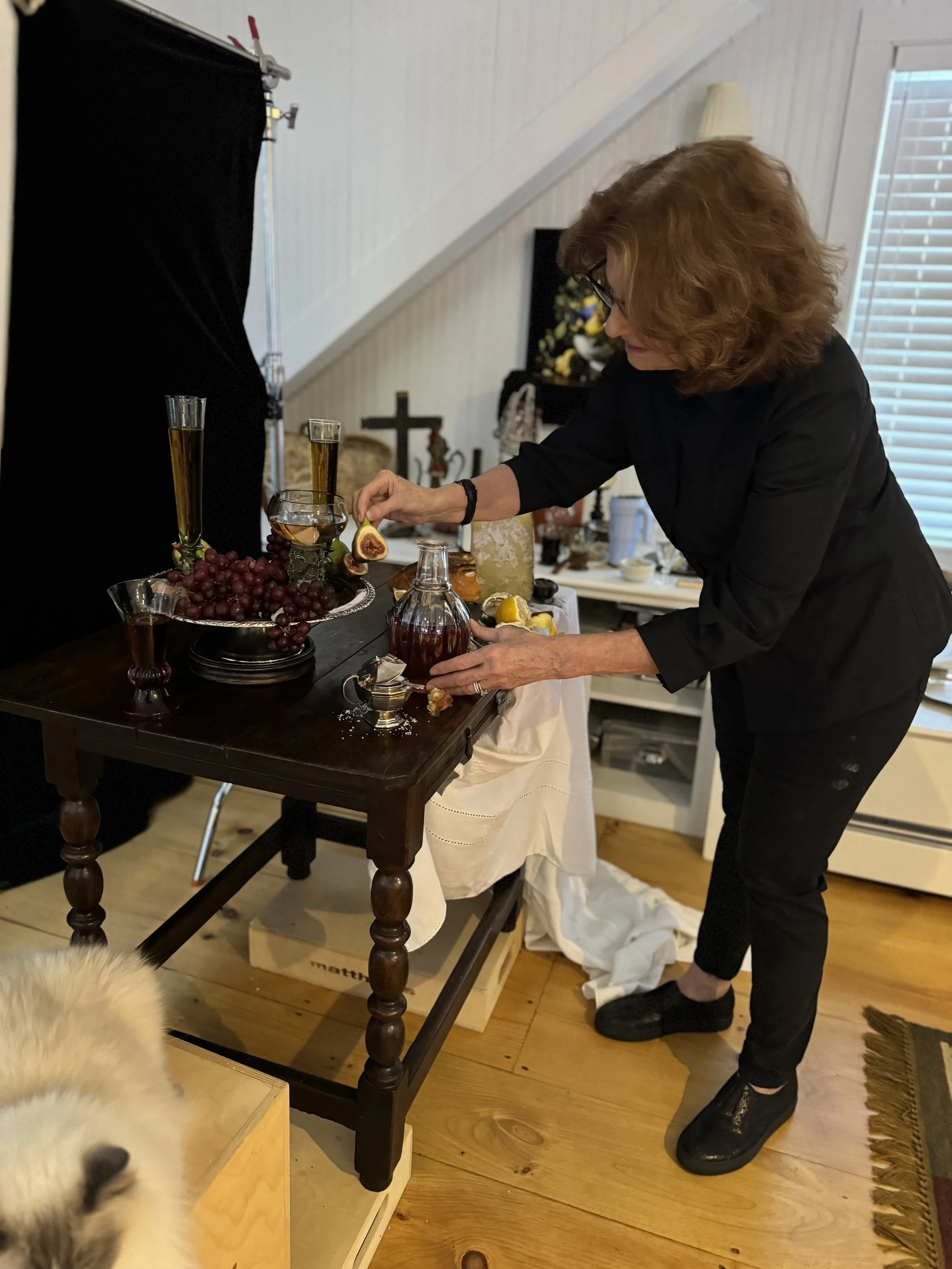 In my studio, arranging a composition where every fig, oyster shell, grape, and Venetian glass tells a story...with Puccini my Ragdoll cat near by.