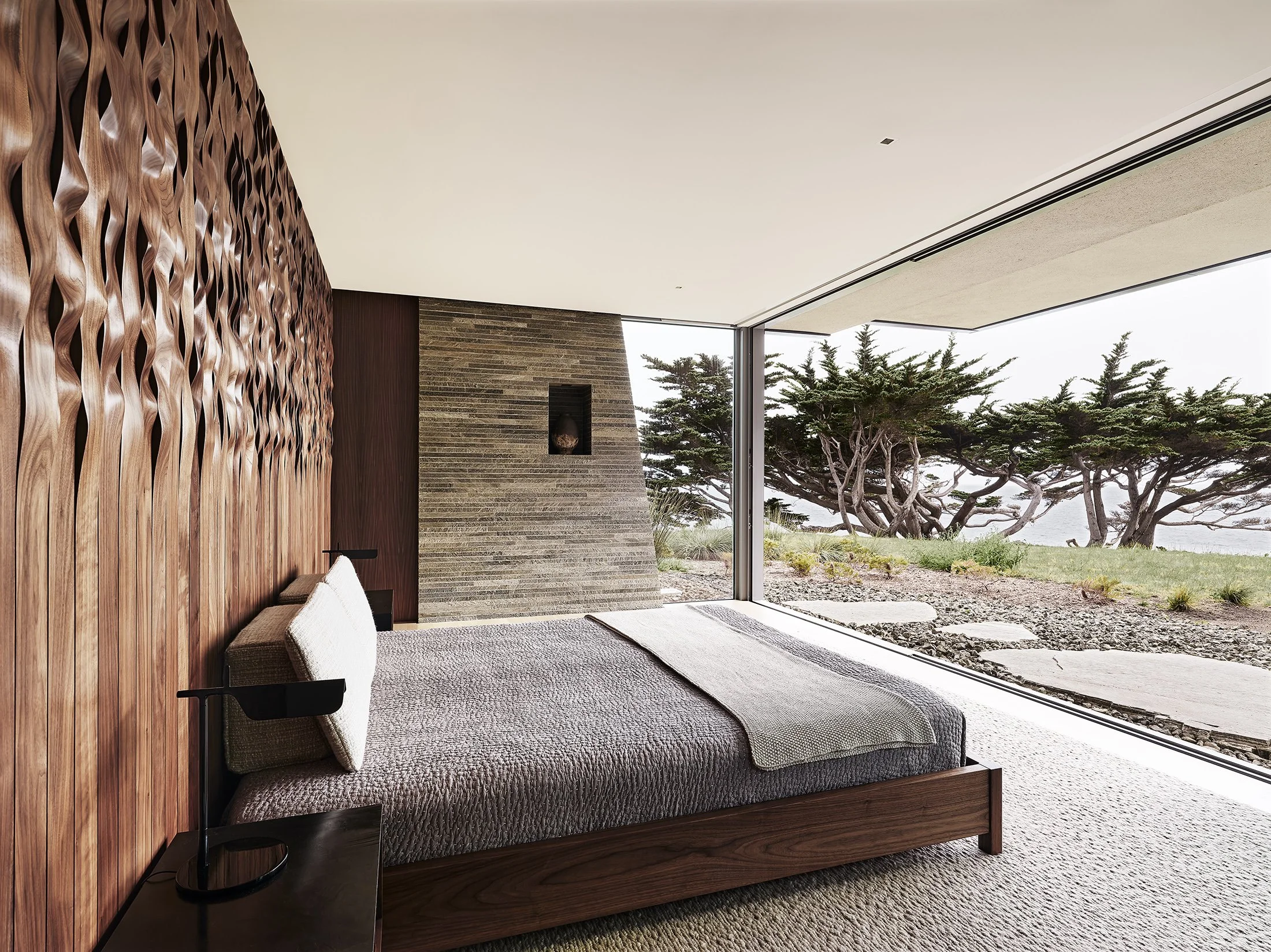 Big Sur bedroom with custom wooden headboard by FIELD Architecture
