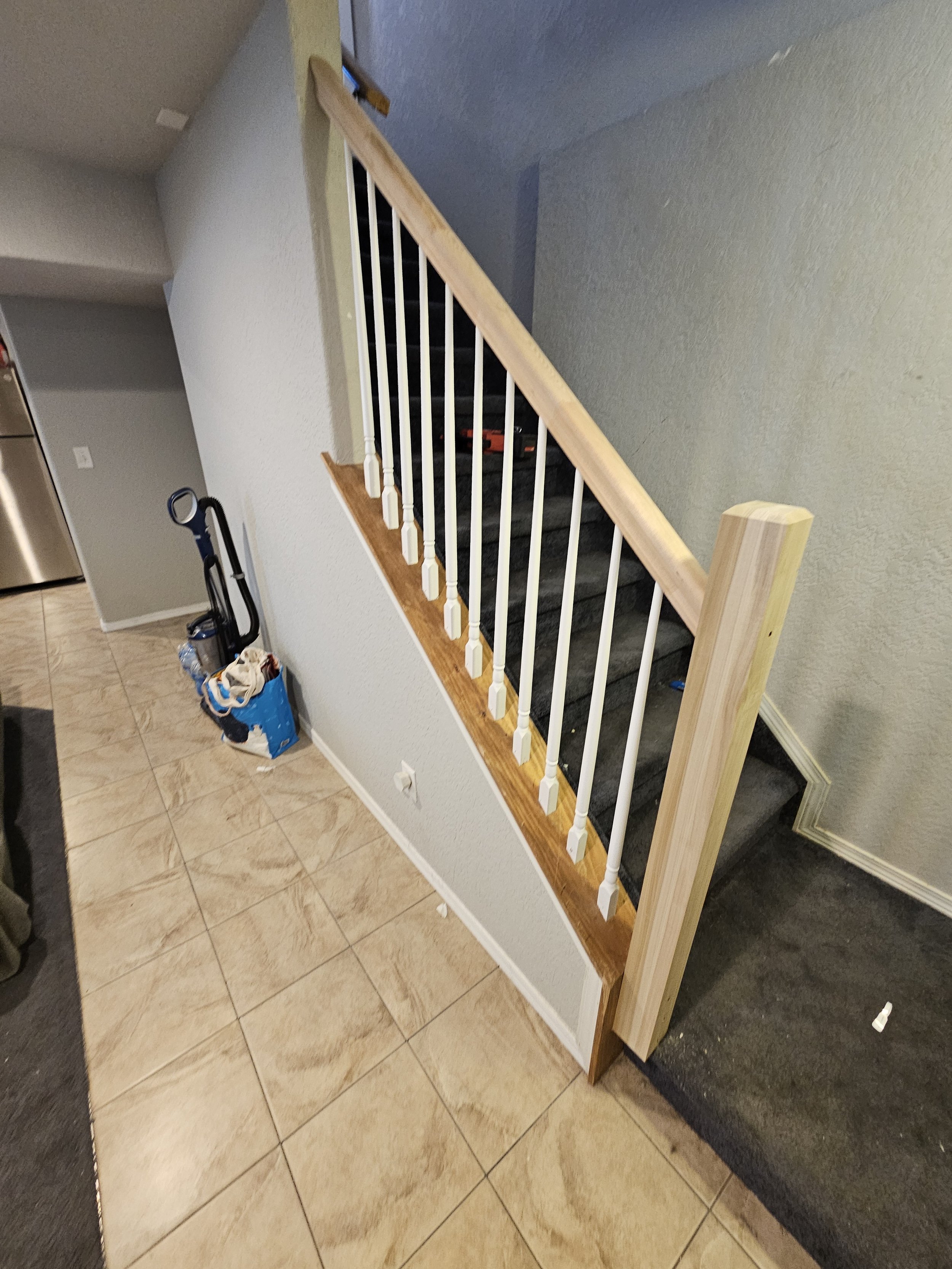 Finished stair railing repair by Colorado Springs handyman
