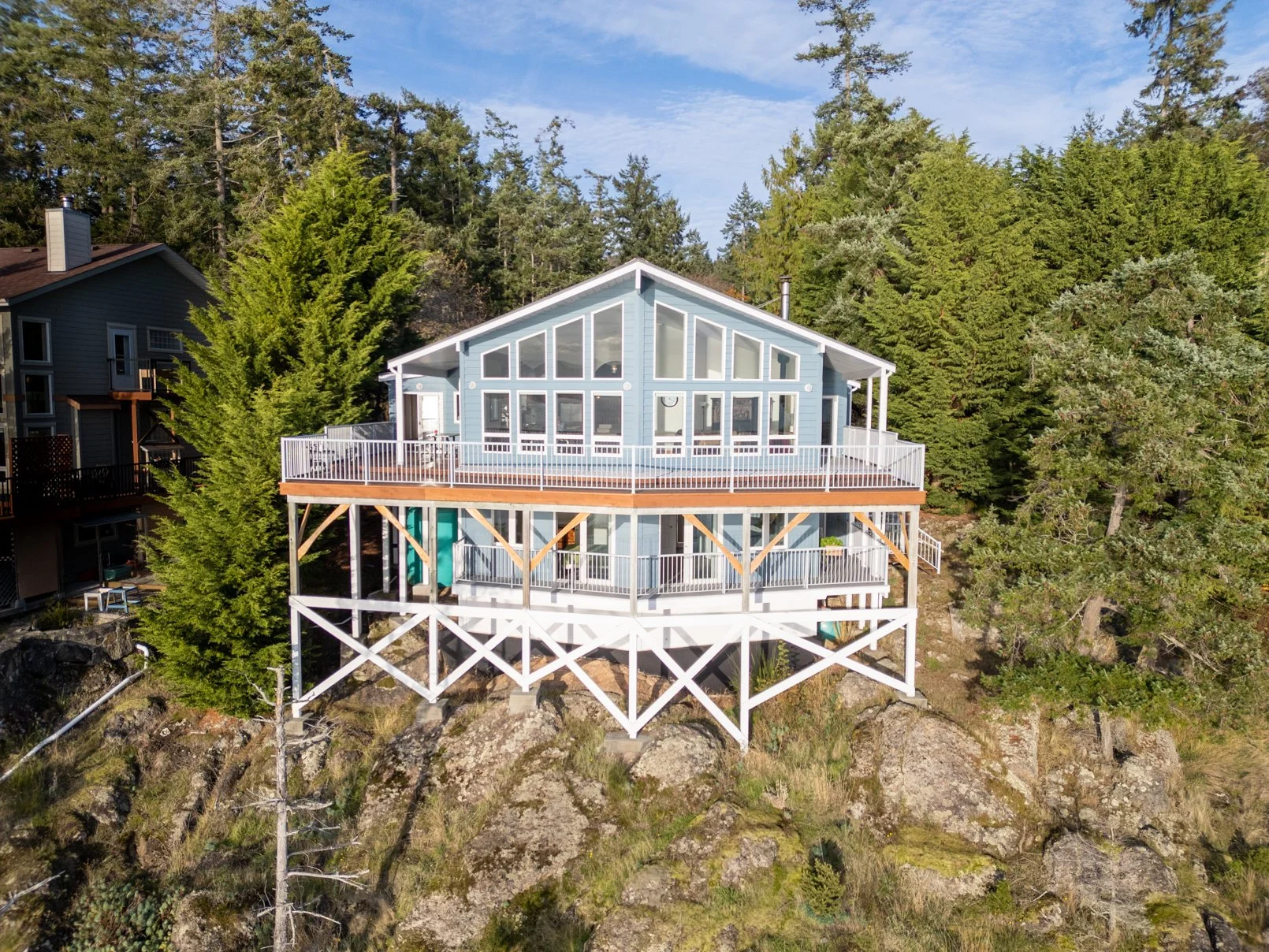 Exterior property photography showcasing the architecture and natural setting of a Pender Island residence.