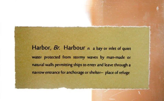 Definition of 'Harbor' printed on paper, describing it as a bay or inlet of quiet water protected from stormy waves by walls, allowing ships to enter and leave for shelter.