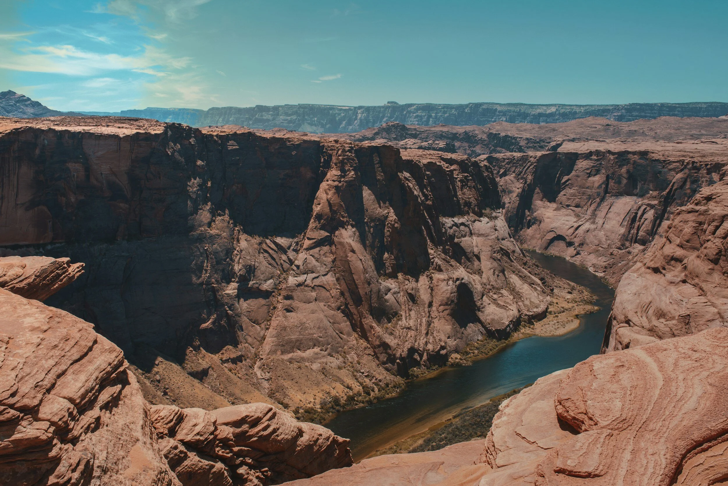 Deep sandstone canyon and Colorado River from Horseshoe Bend