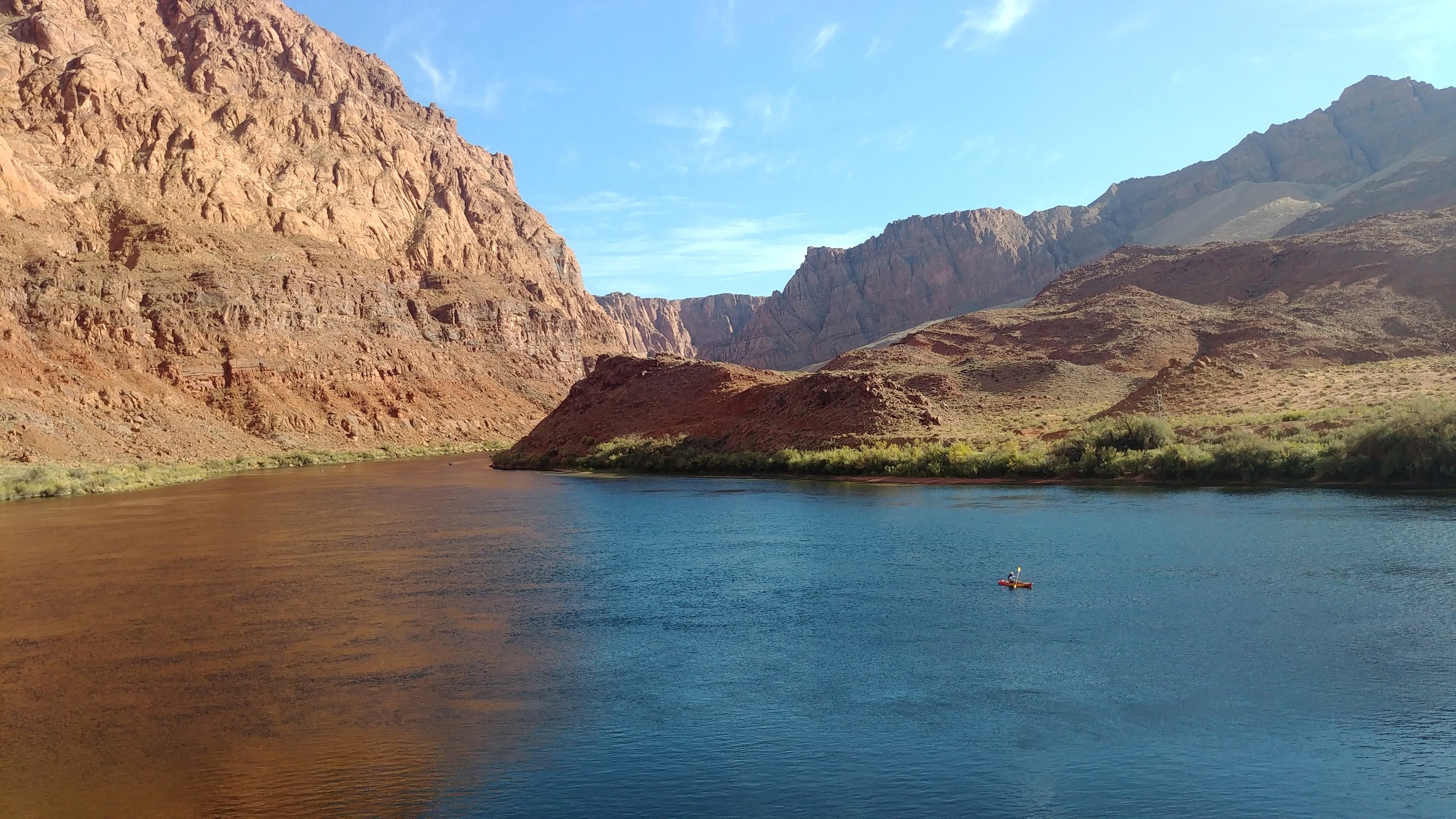 Distant kayaker in the middle of the Colorado River gorge