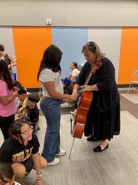 Student learns with hands-on cello.jpg