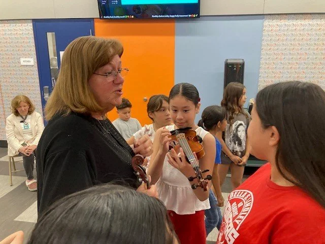 Musician shows students the violin.jpg