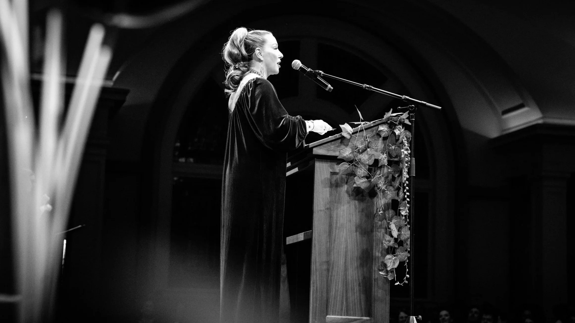 woman speaking at podium on stage