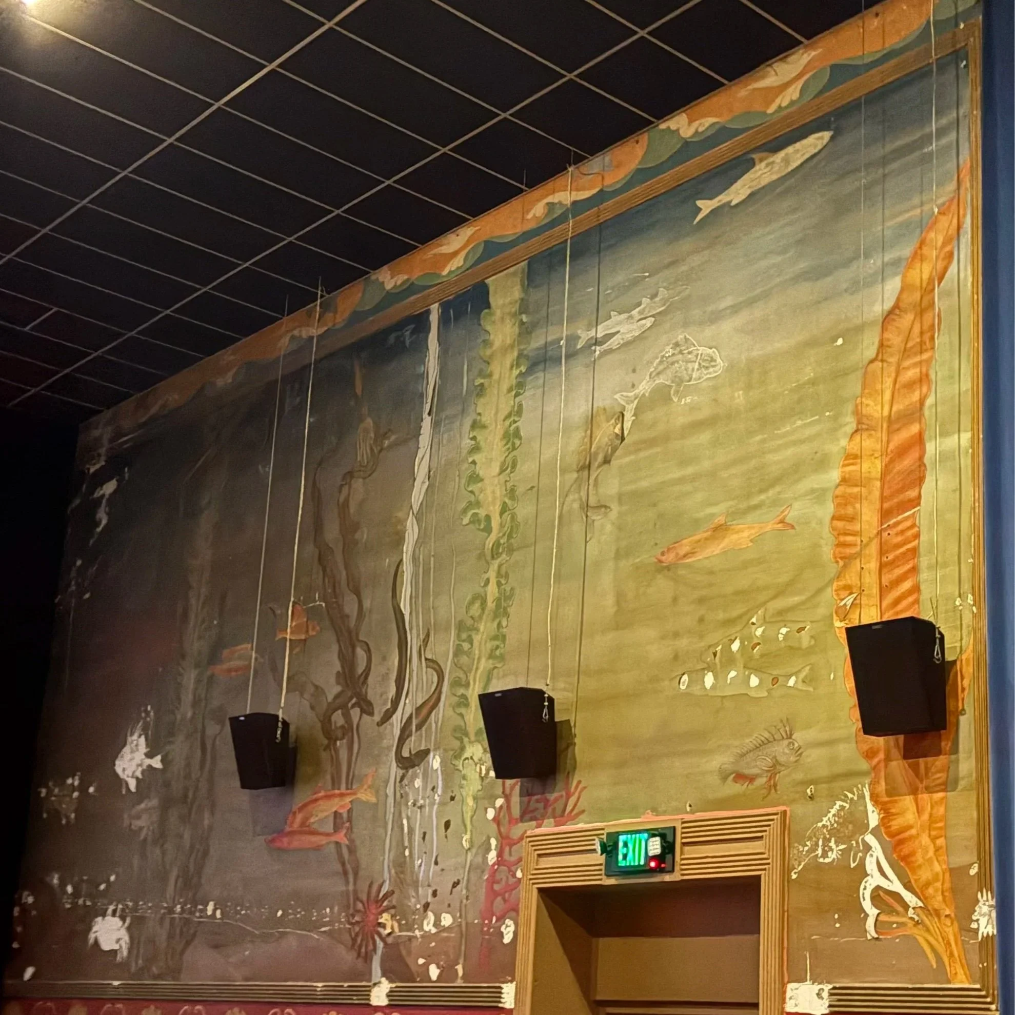 nautical mural inside Pier 4 at The Admiral; faded undersea fish, seaweed, coral. Potential water damage.
