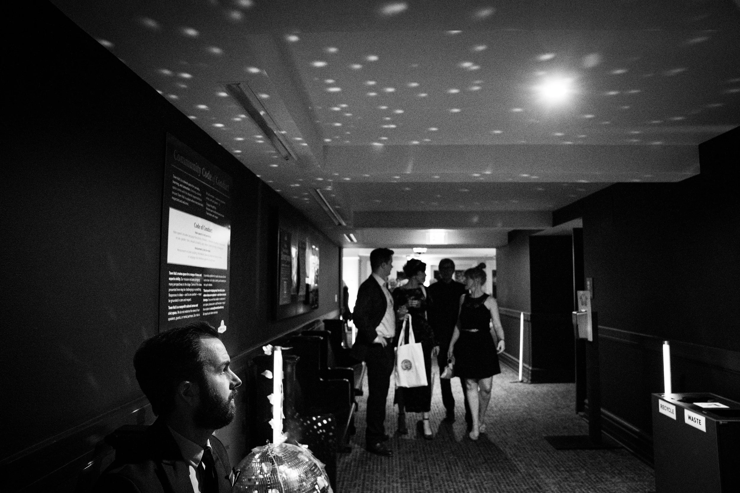 hallway between main rooms, people walking or sitting, at Town Hall