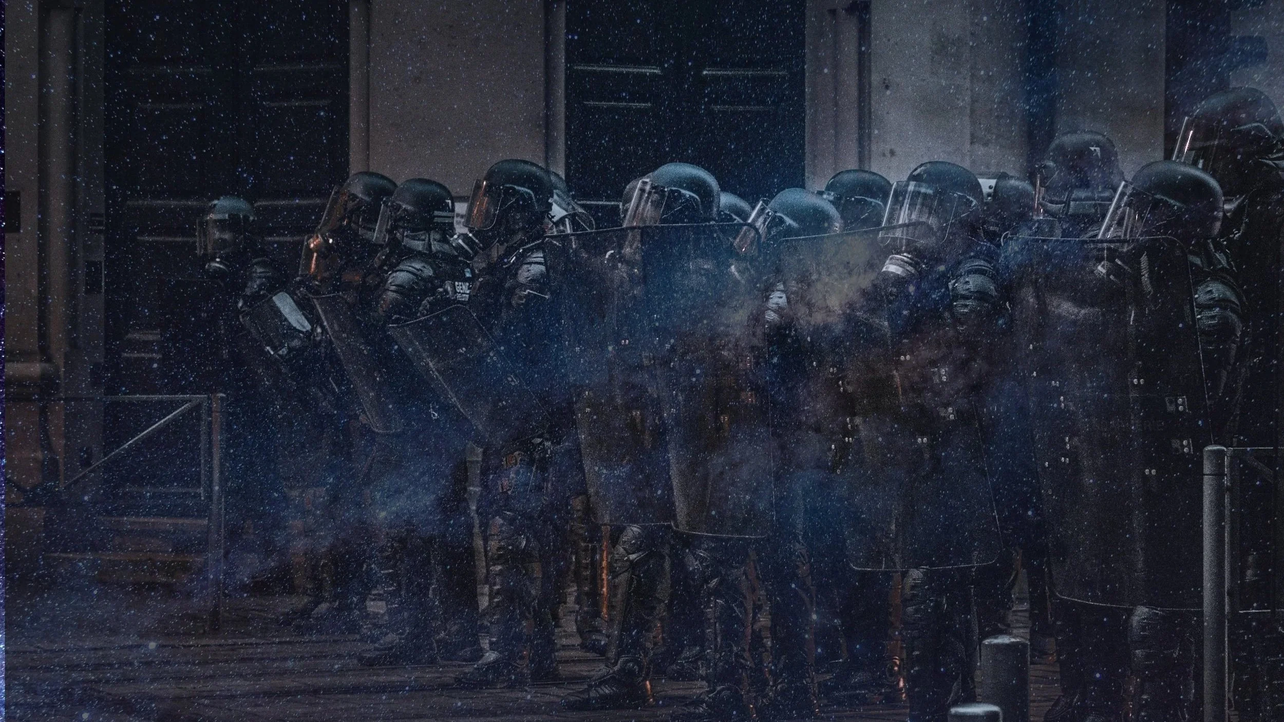 overlay of a galaxy image by Graham Holtshausen and a riot police image by Jean on Unsplash