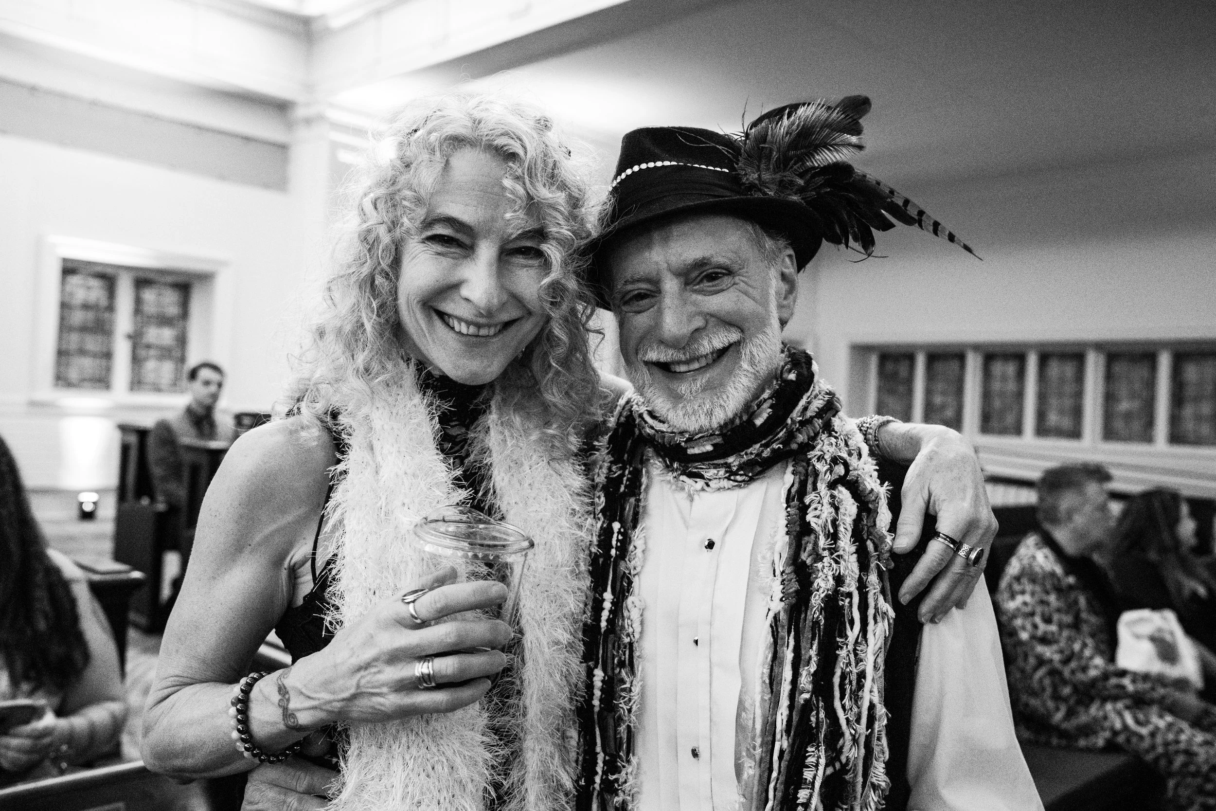 a couple dressed up and smiling at the camera