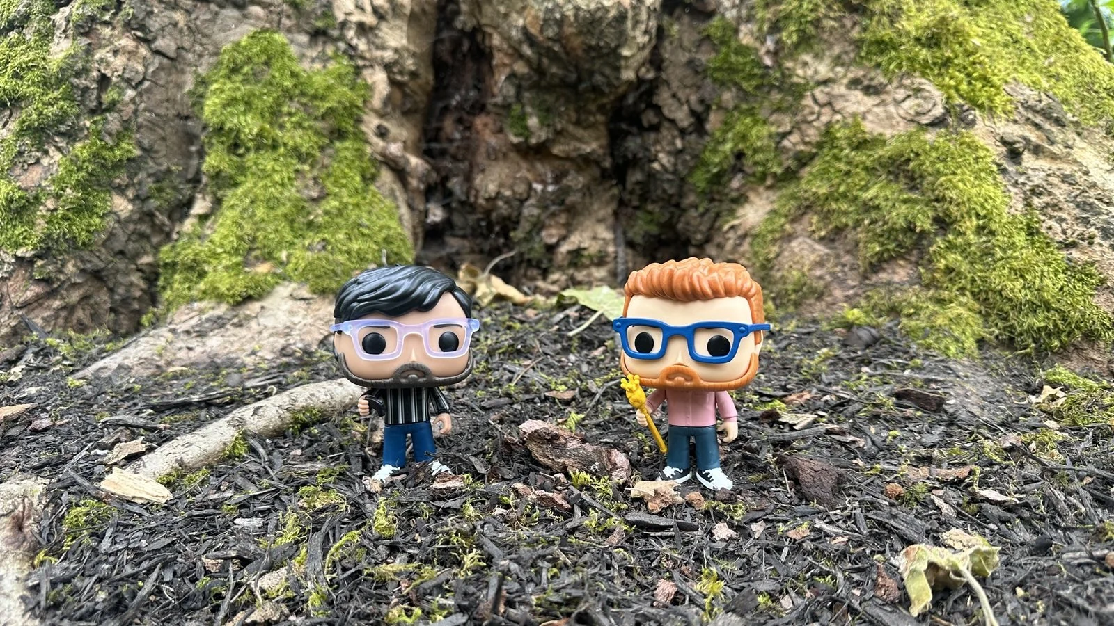 two personalized Funko Pops standing 3 inches apart on top of a slope, facing slightly upward