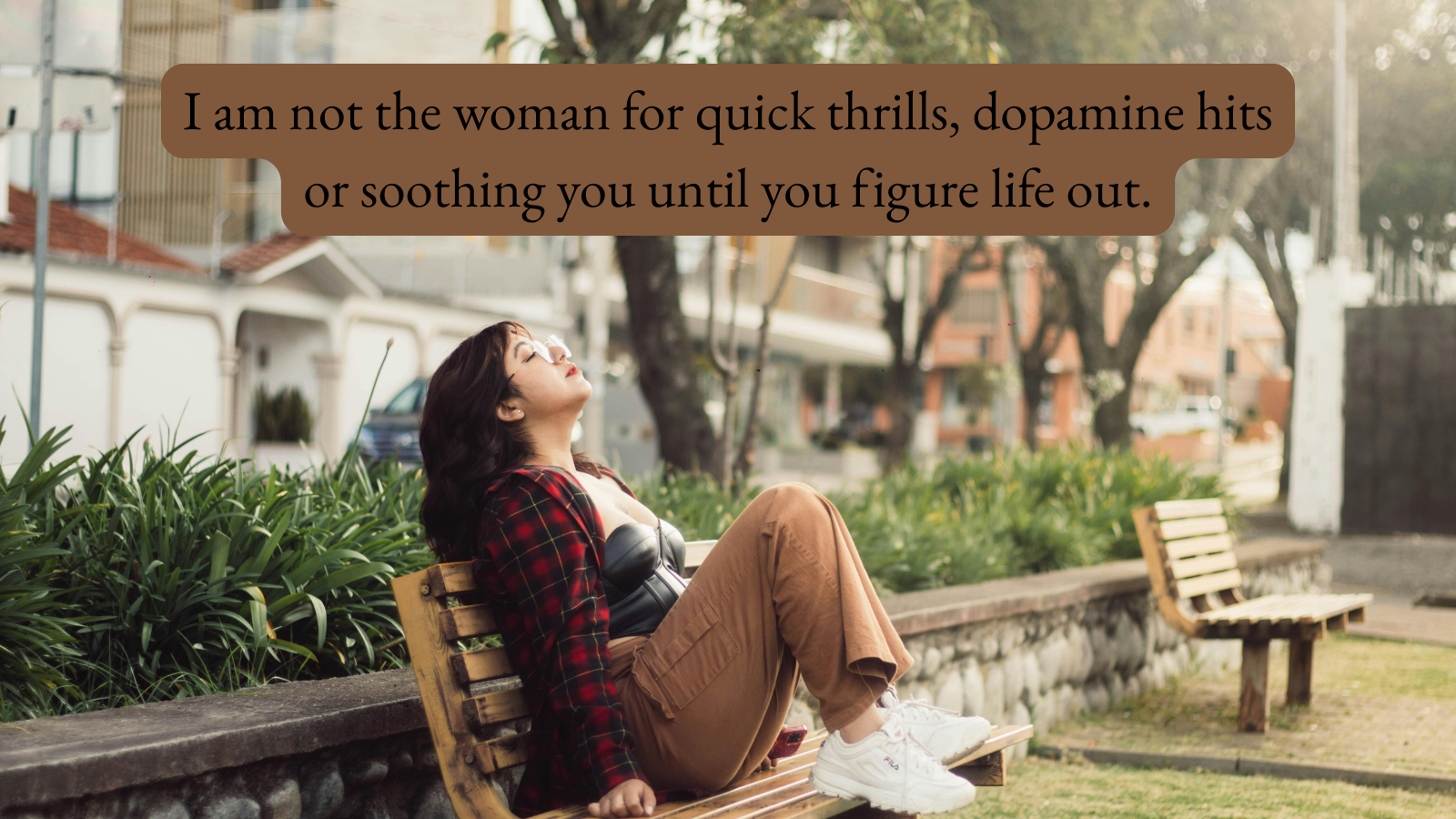 young person sitting on a bench with knees up on seat, face leaning up to the sky with eyes closed. Overlay caption