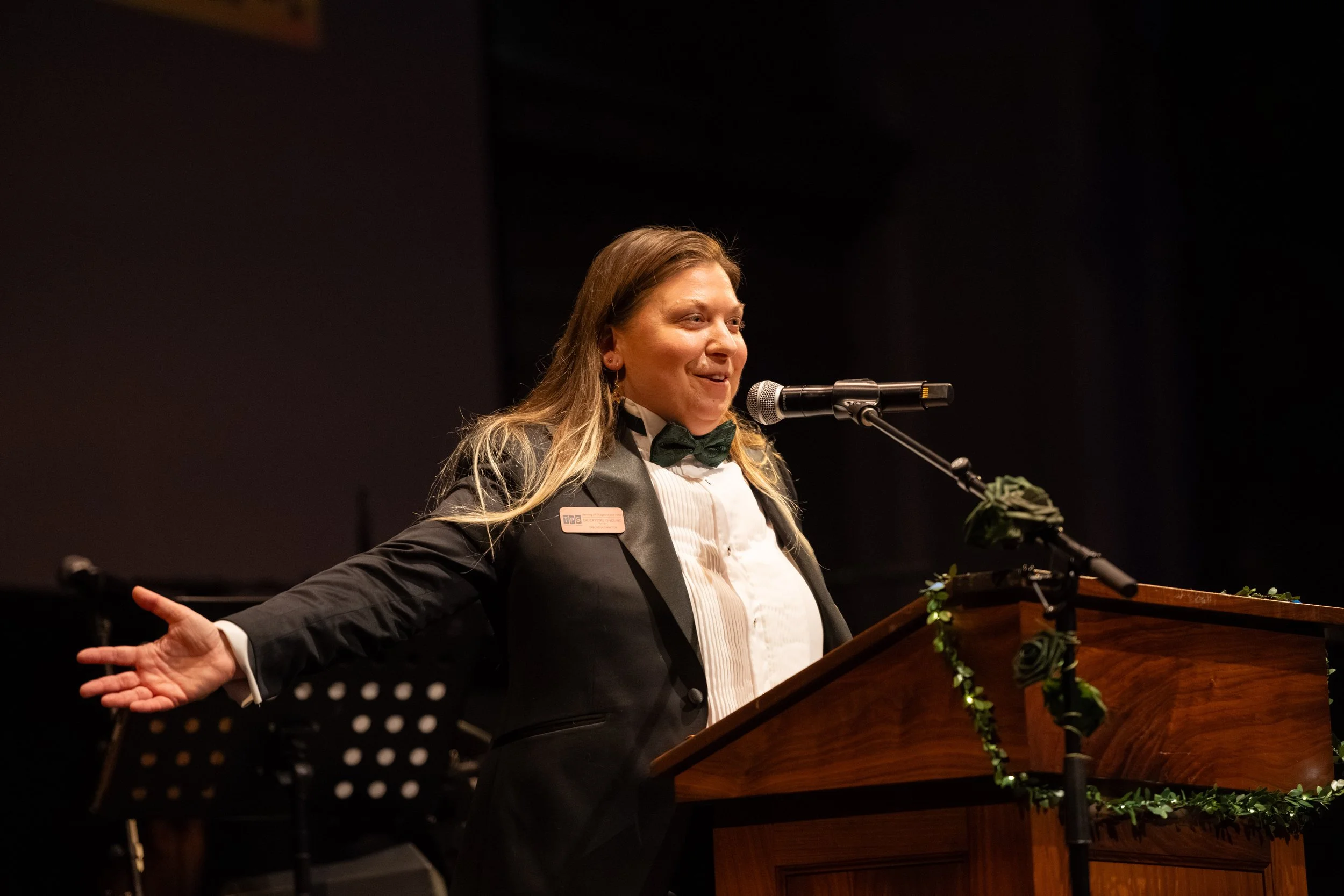 Dr. Crystal Yingling of Theatre Puget Sound on stage at a podium