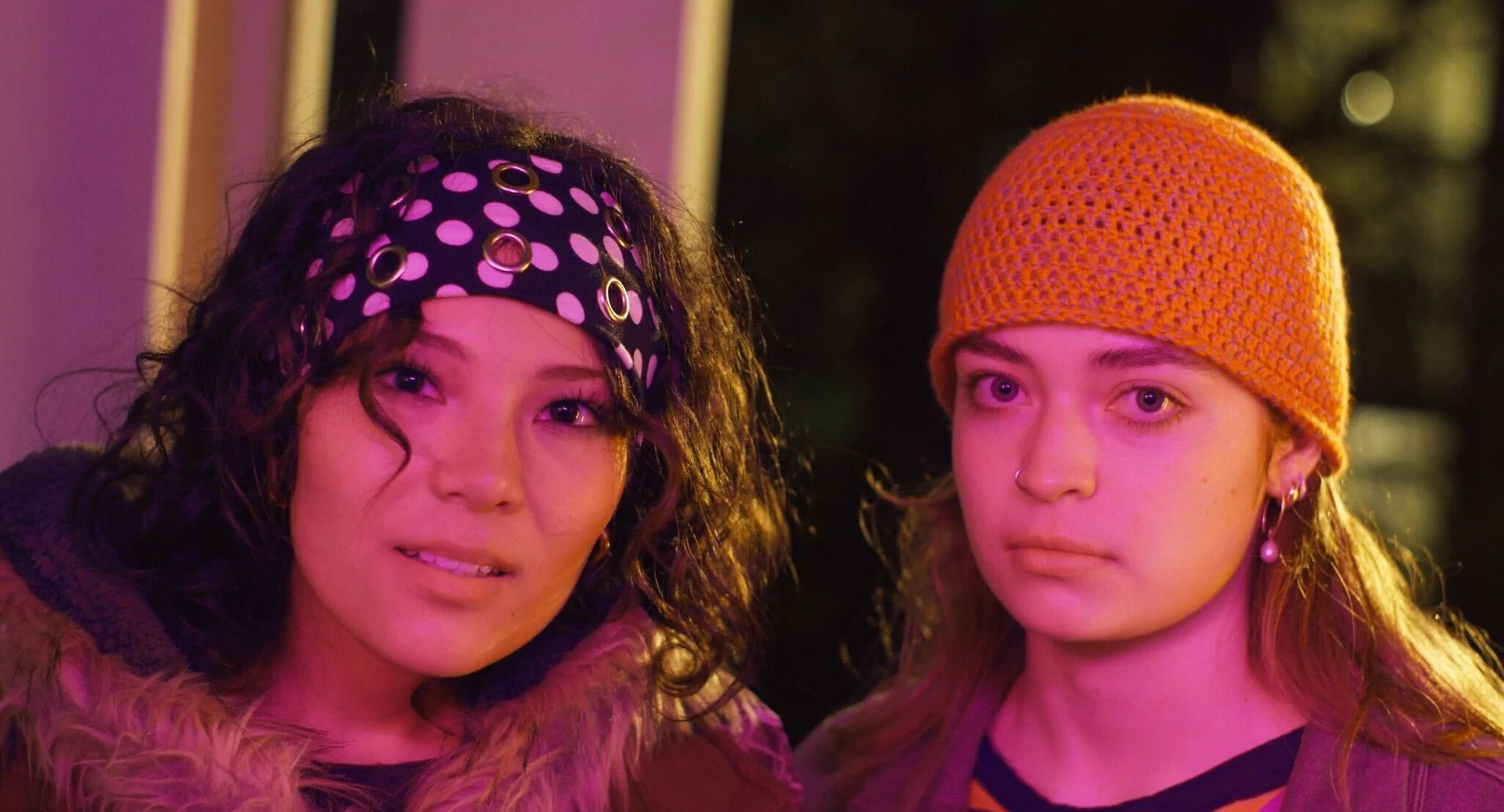 two femme characters look into the camera in All for the Gram