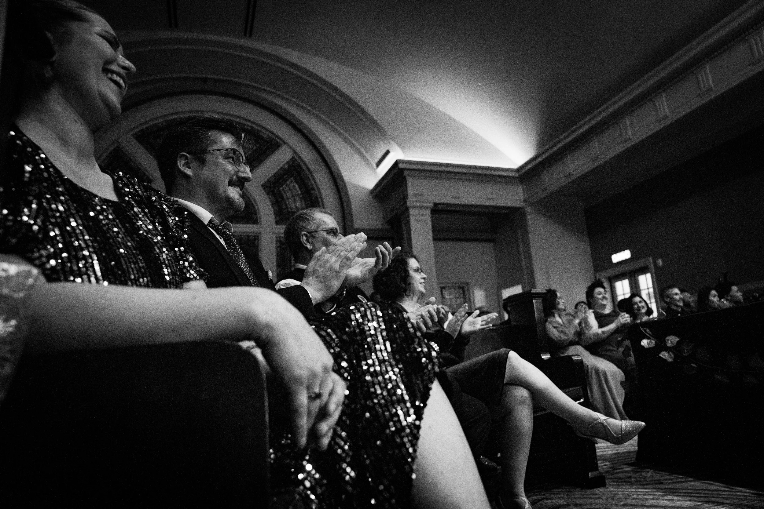 audience applauding and smiling while seated