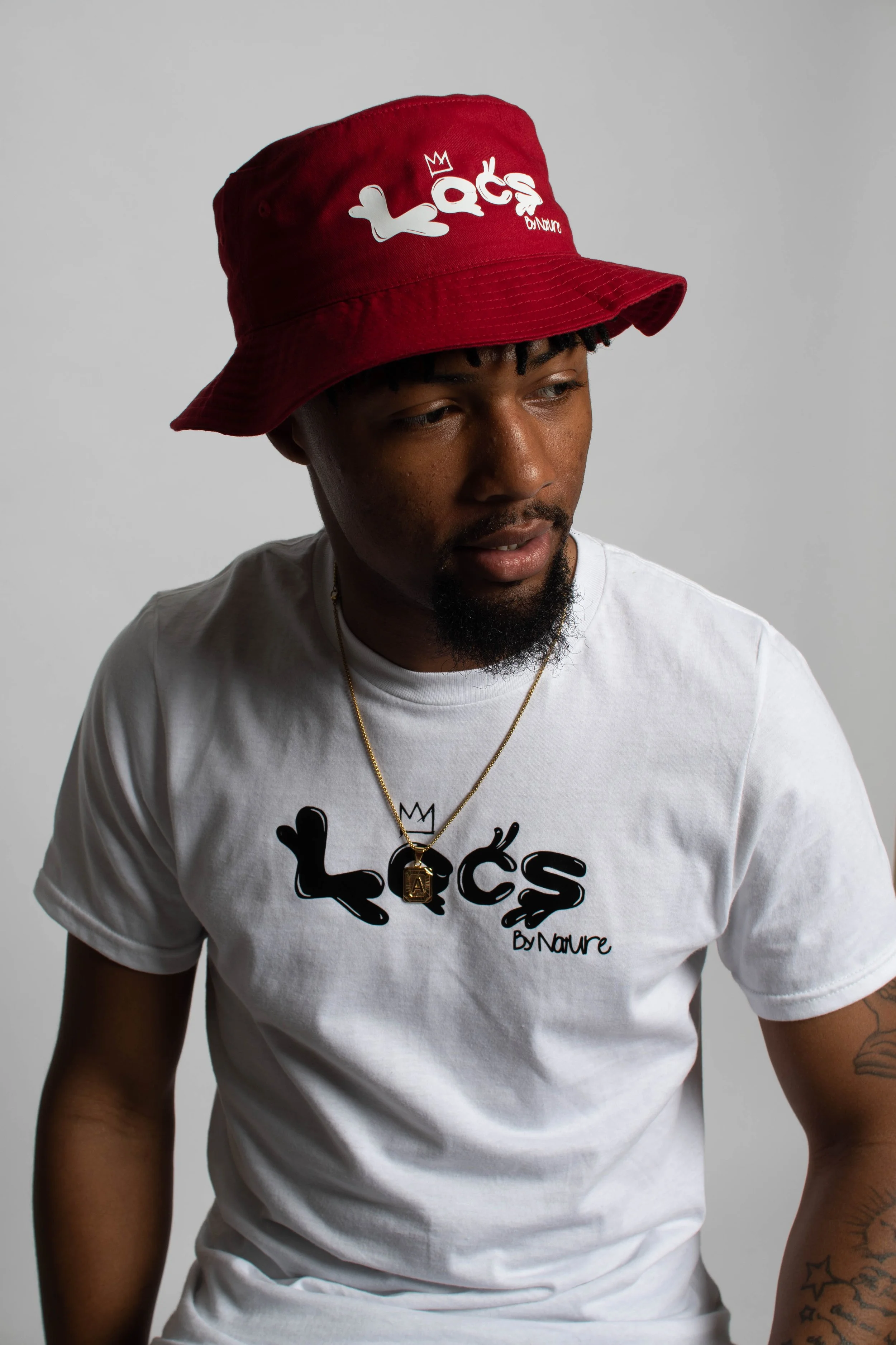 Laurie’s customers, Mariana and Carmen holding hands on a green lawn on their wedding day.