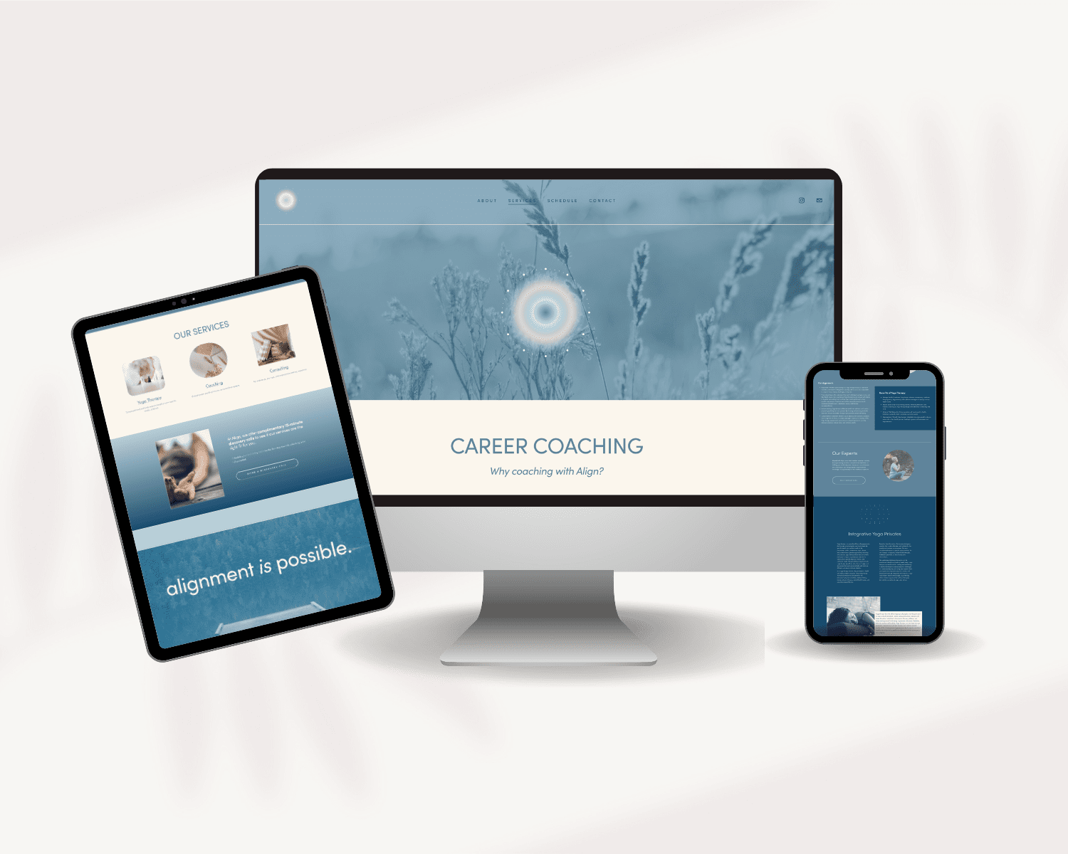 Computer monitor displaying career coaching website, tablet showing services with text 'alignment is possible,' and smartphone with website content, all set against a plain, light-colored background.