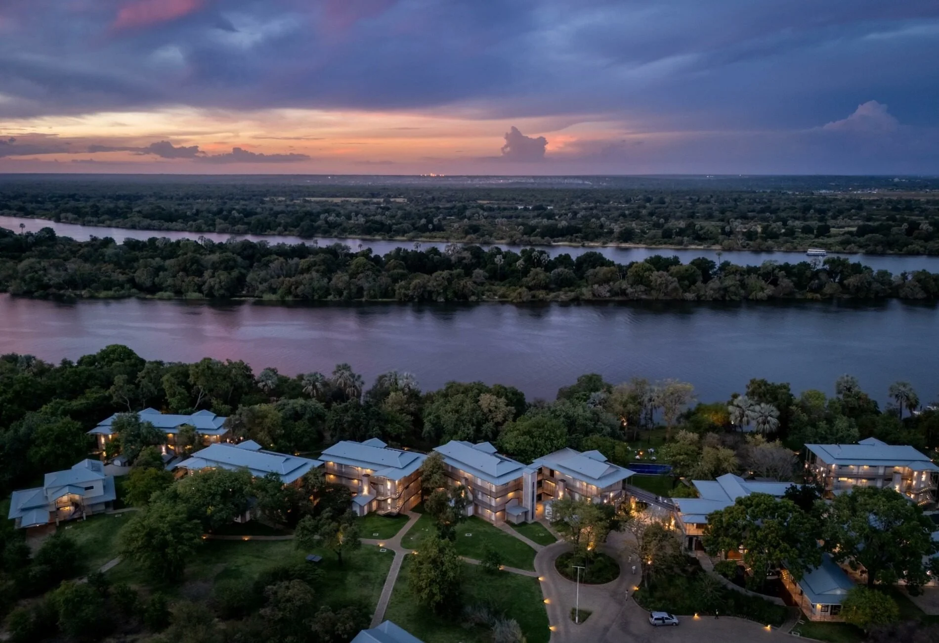 An aerial view of The Palm River Hotel on the banks of the Zambezi at dusk