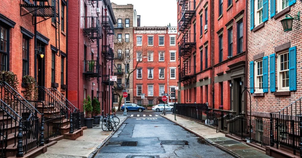 Red brick townhouses lining a quiet street in New York