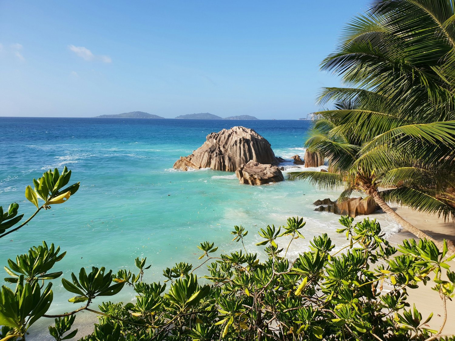 Granite boulders and turquoise water on a beach in the Seychelles