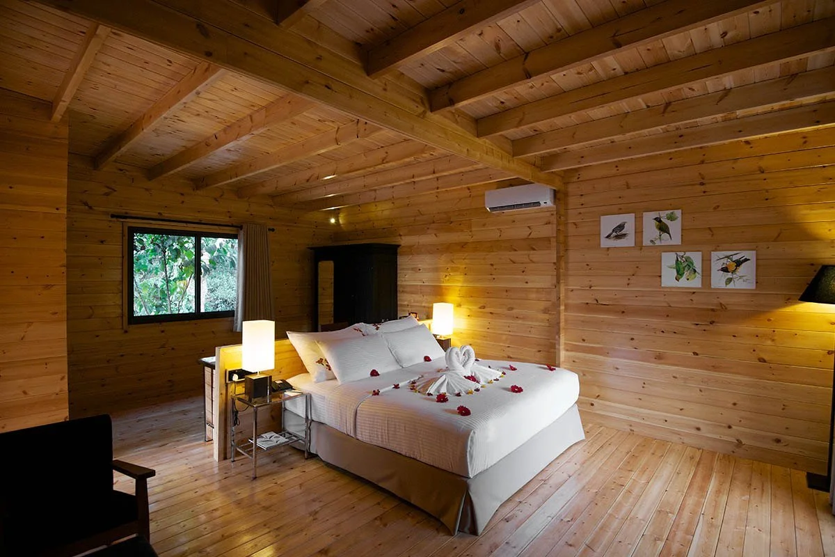 A wood-panelled Garden Chalet bedroom at Mountbatten Bungalow