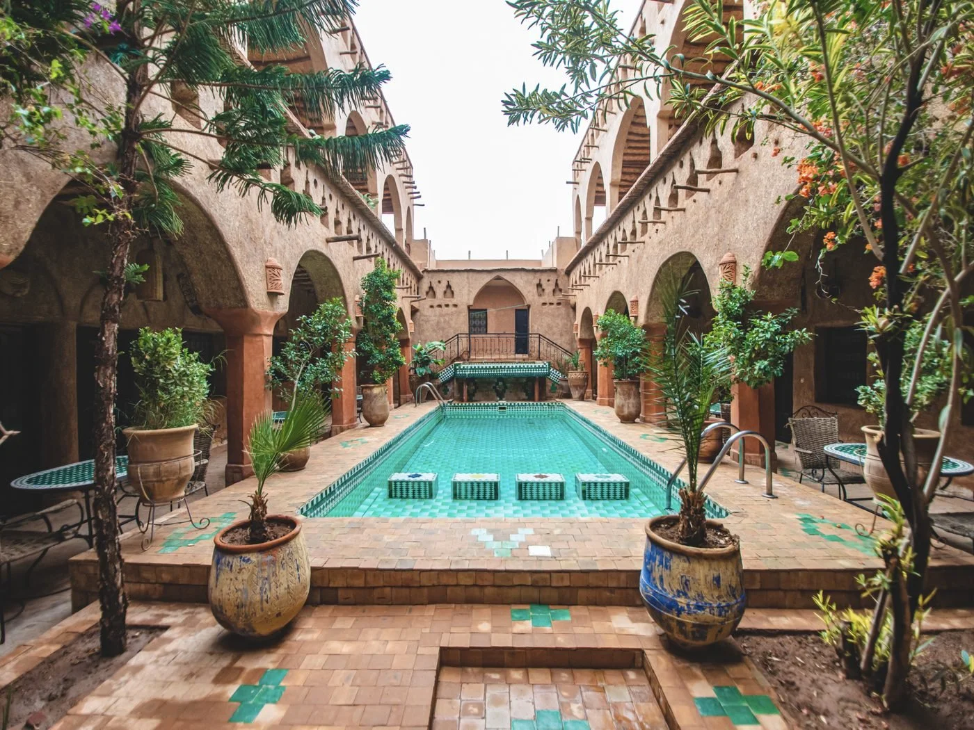 A tiled pool in the arched courtyard of a traditional Moroccan riad