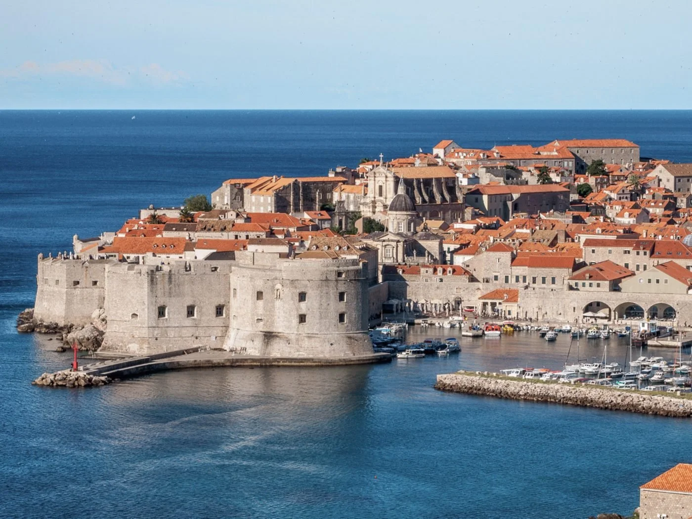 The walled old town and harbour of Dubrovnik in Croatia beneath terracotta rooftops