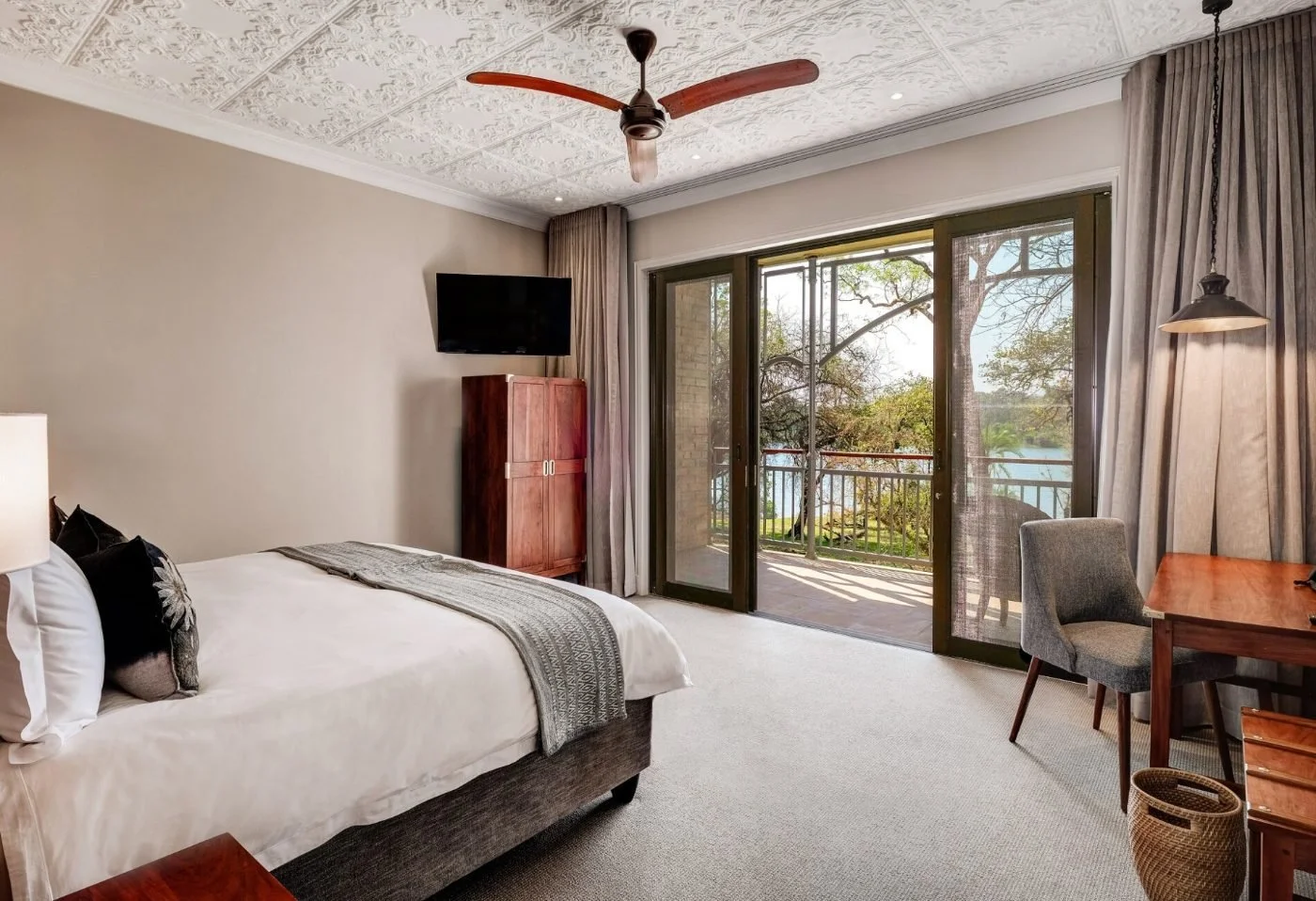 A Deluxe Room at The Palm River Hotel, with sliding doors to a balcony