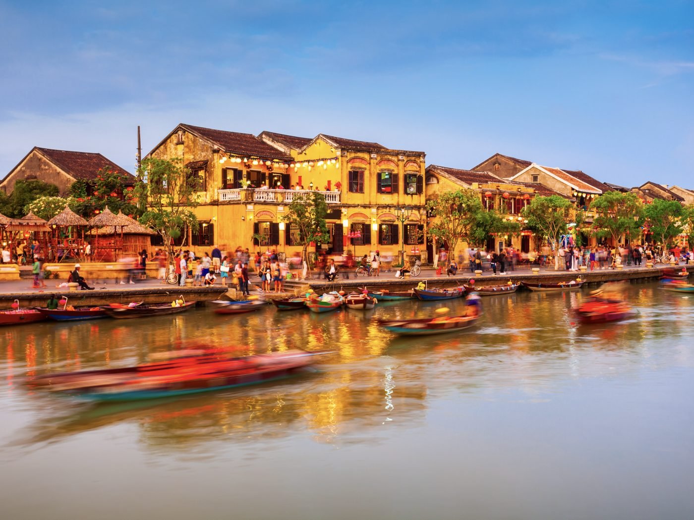 Lantern-lit merchant houses along the river in Hoi An, Vietnam, at dusk