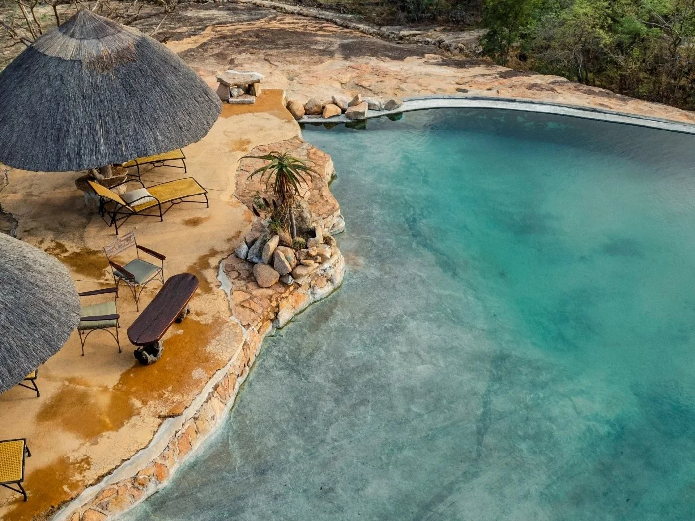 The natural rock infinity pool at Amalinda Lodge from above