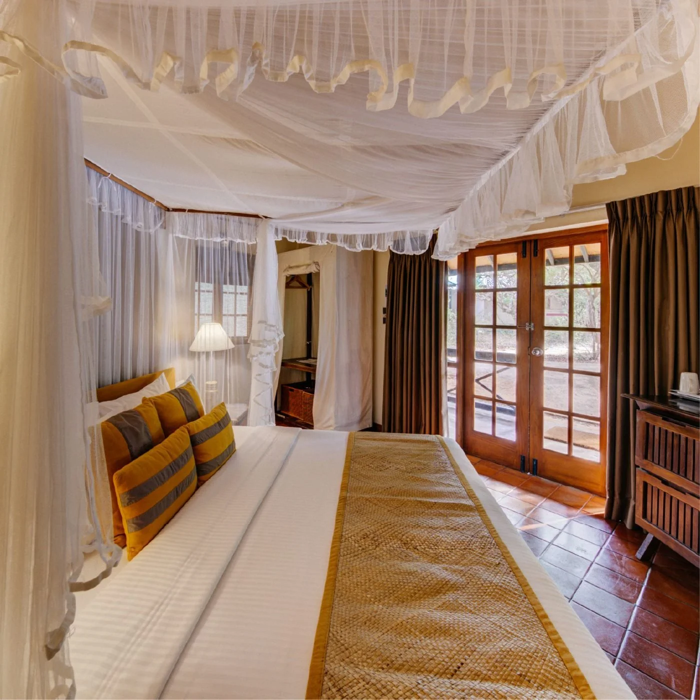 A Jungle Chalet bedroom with a canopy bed at Cinnamon Wild Yala