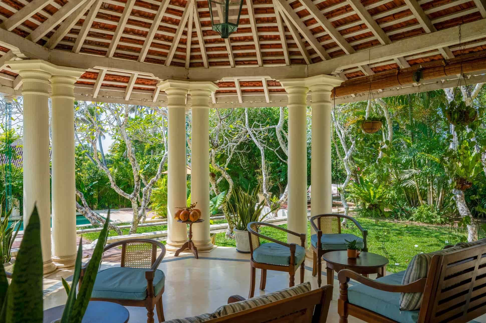 The columned veranda of The Sun House opening onto its tropical garden