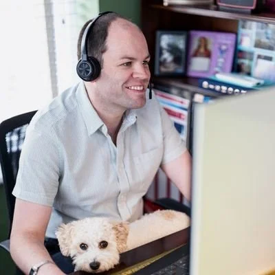 Ben from Huben Travel on the phone with a guest