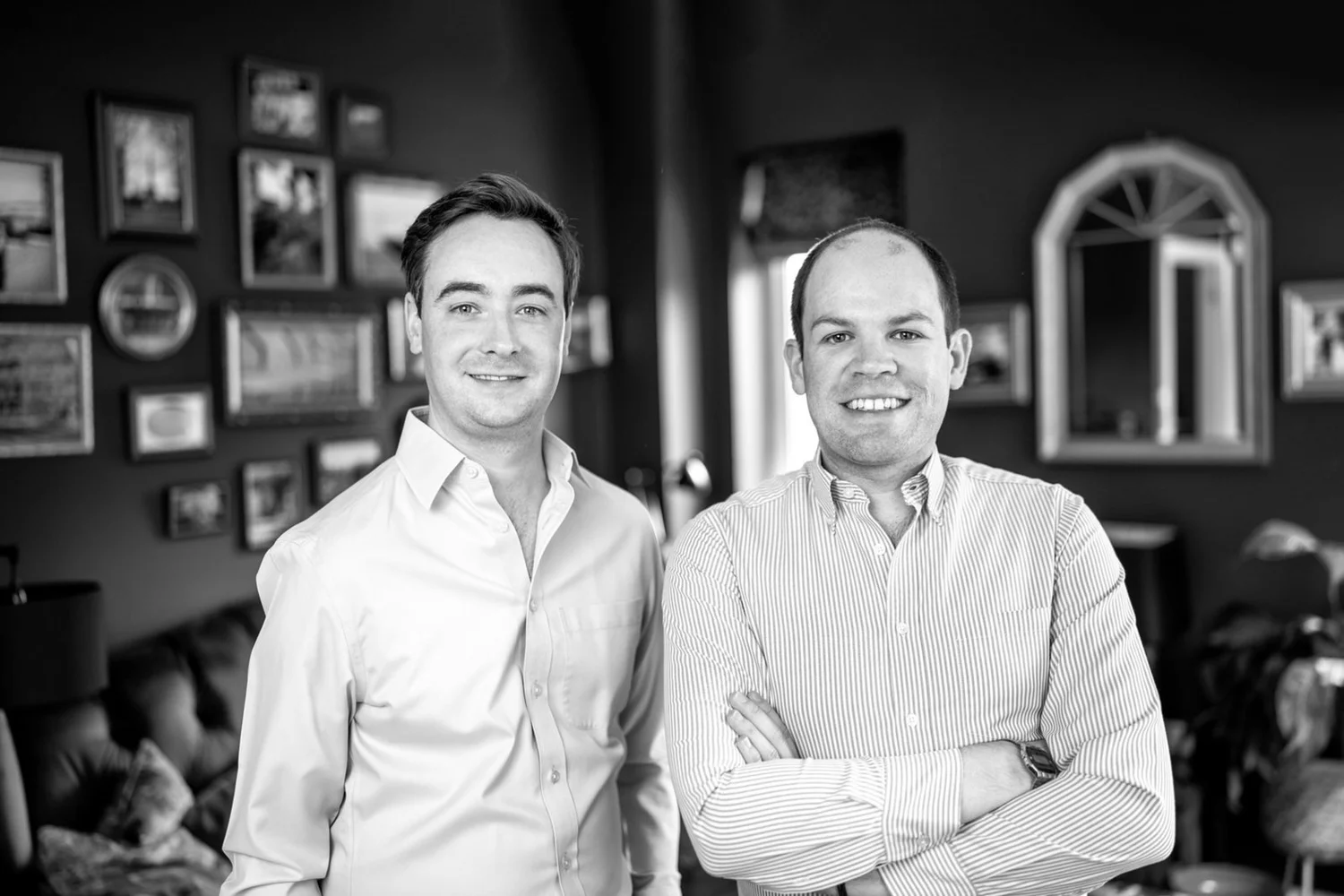 Black and white portrait of Hugh and Ben, the founders of Huben Travel, standing side by side at home