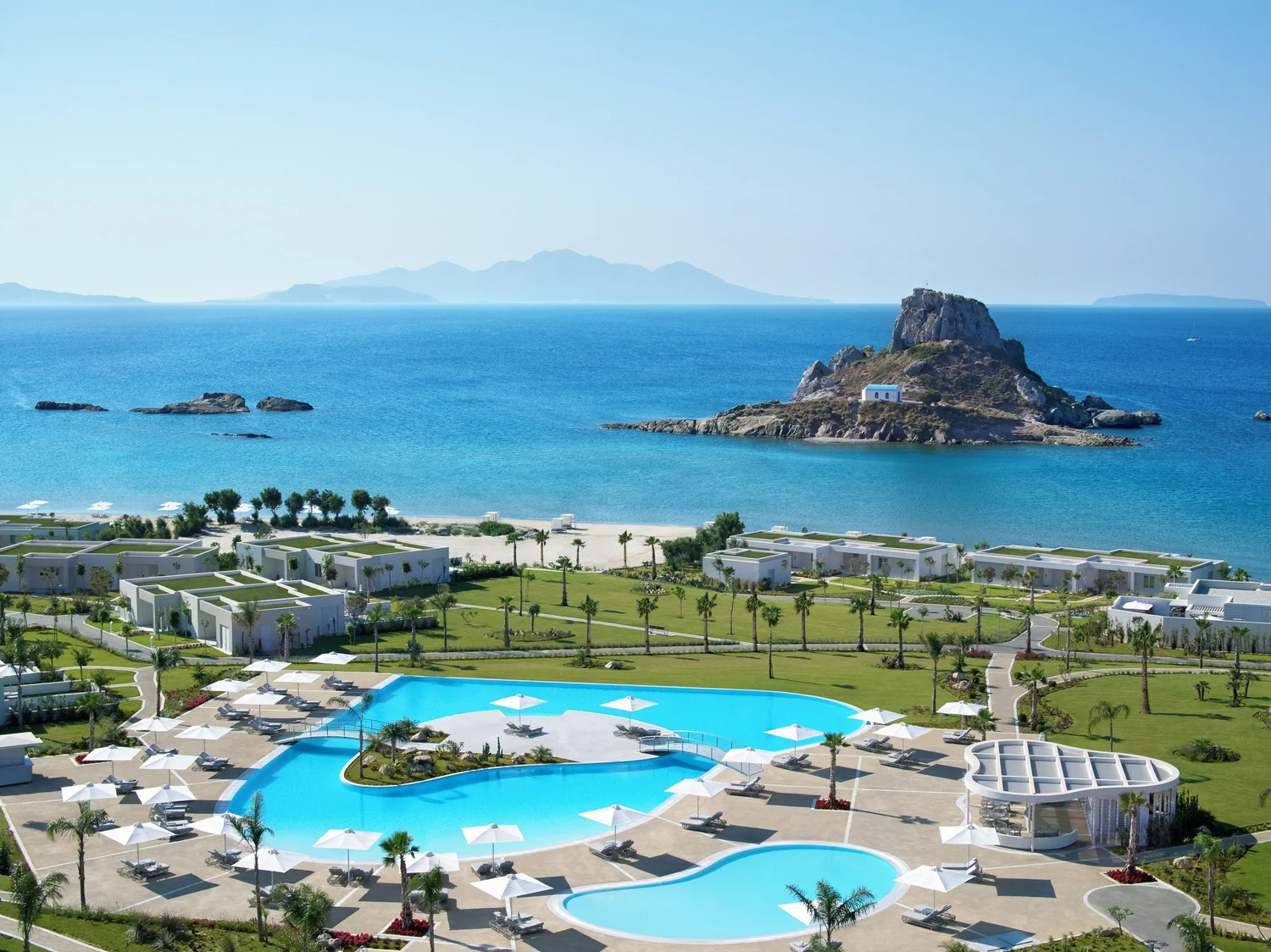Pools and gardens of an Ikos resort beside the Aegean Sea