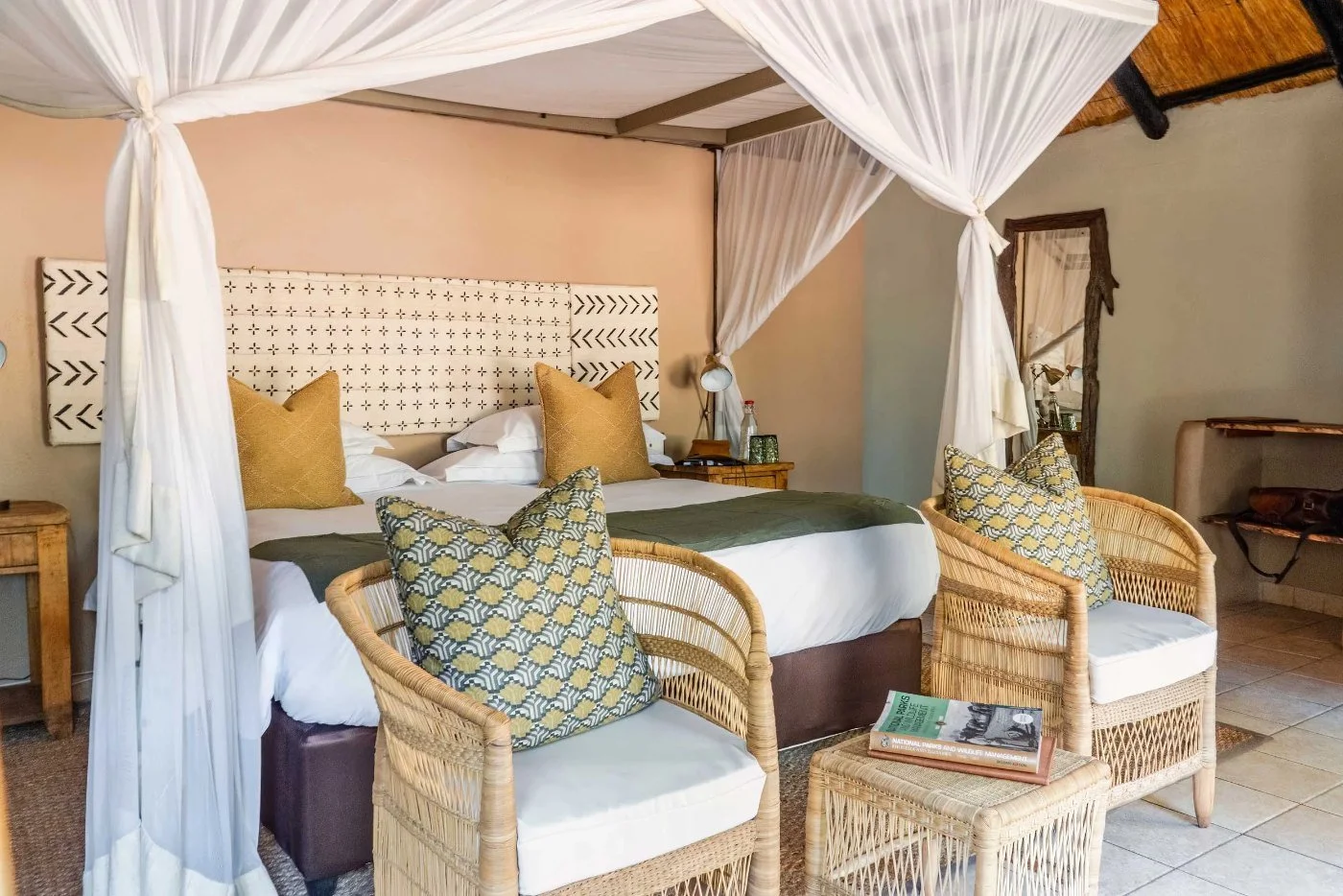 A rondavel bedroom at Sable Valley, with a mosquito net over the bed