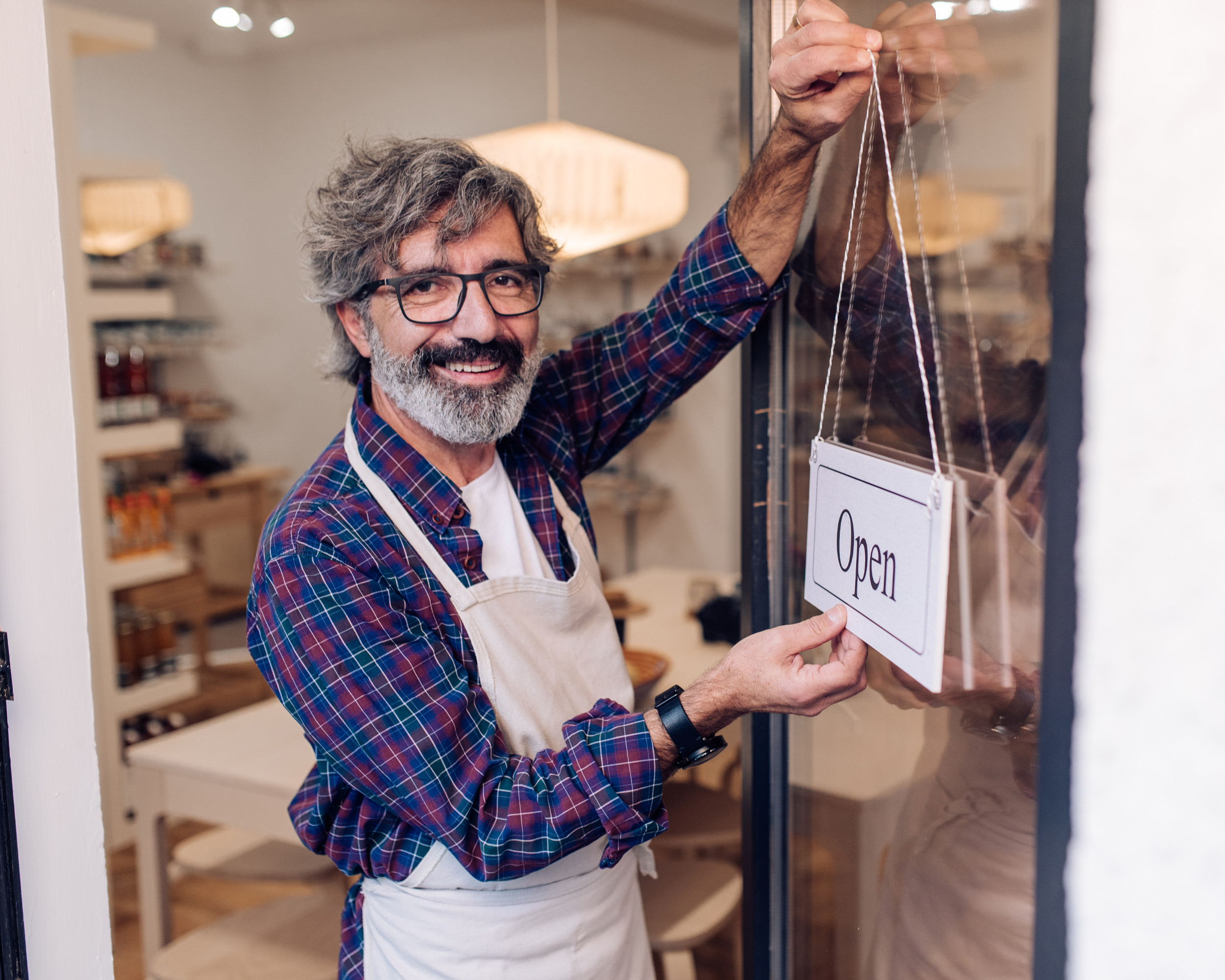 Image of a local business man opening his shop, ready to start the local presence of his business.