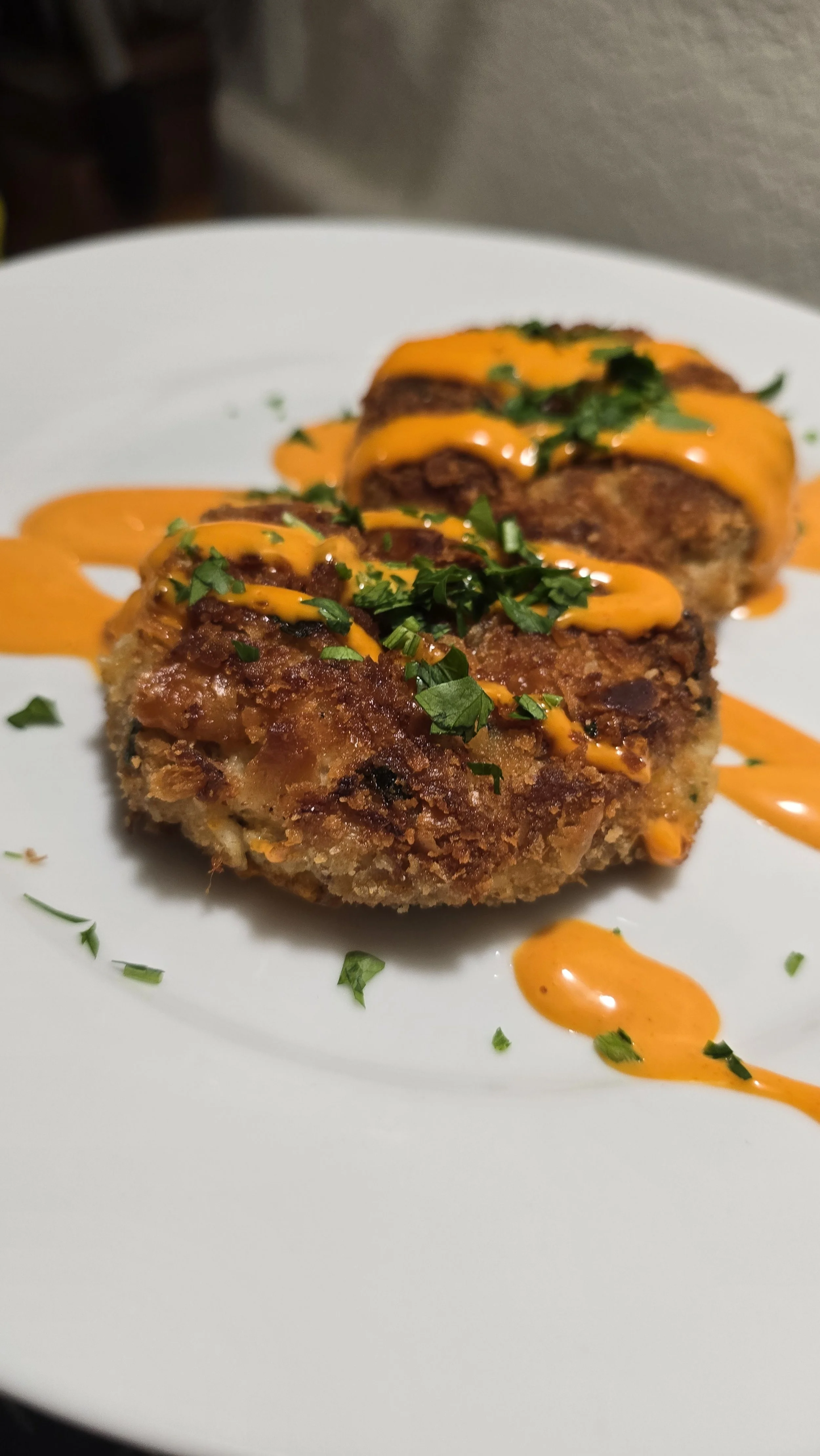 Golden crab cakes with spicy orange aioli – bold appetizer served at catered gatherings and upscale private dinners