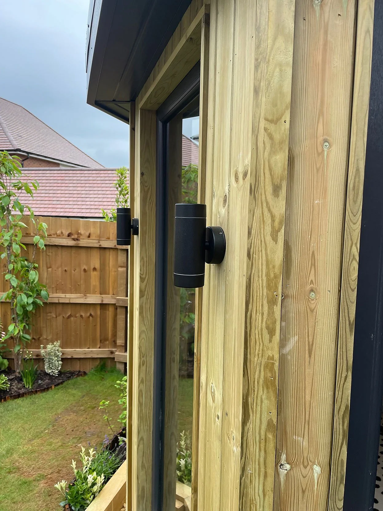  A black light illuminating a garden room with a door. 