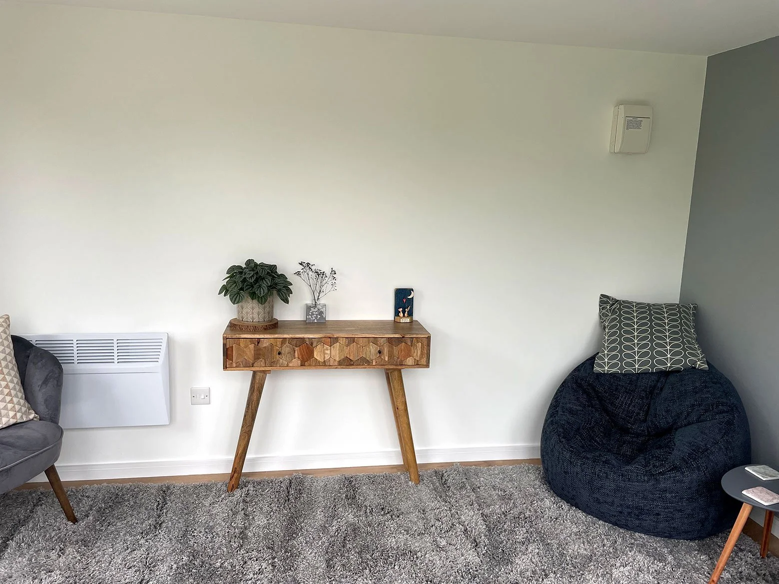  A cozy living room featuring a comfortable bean bag chair and a stylish table. 