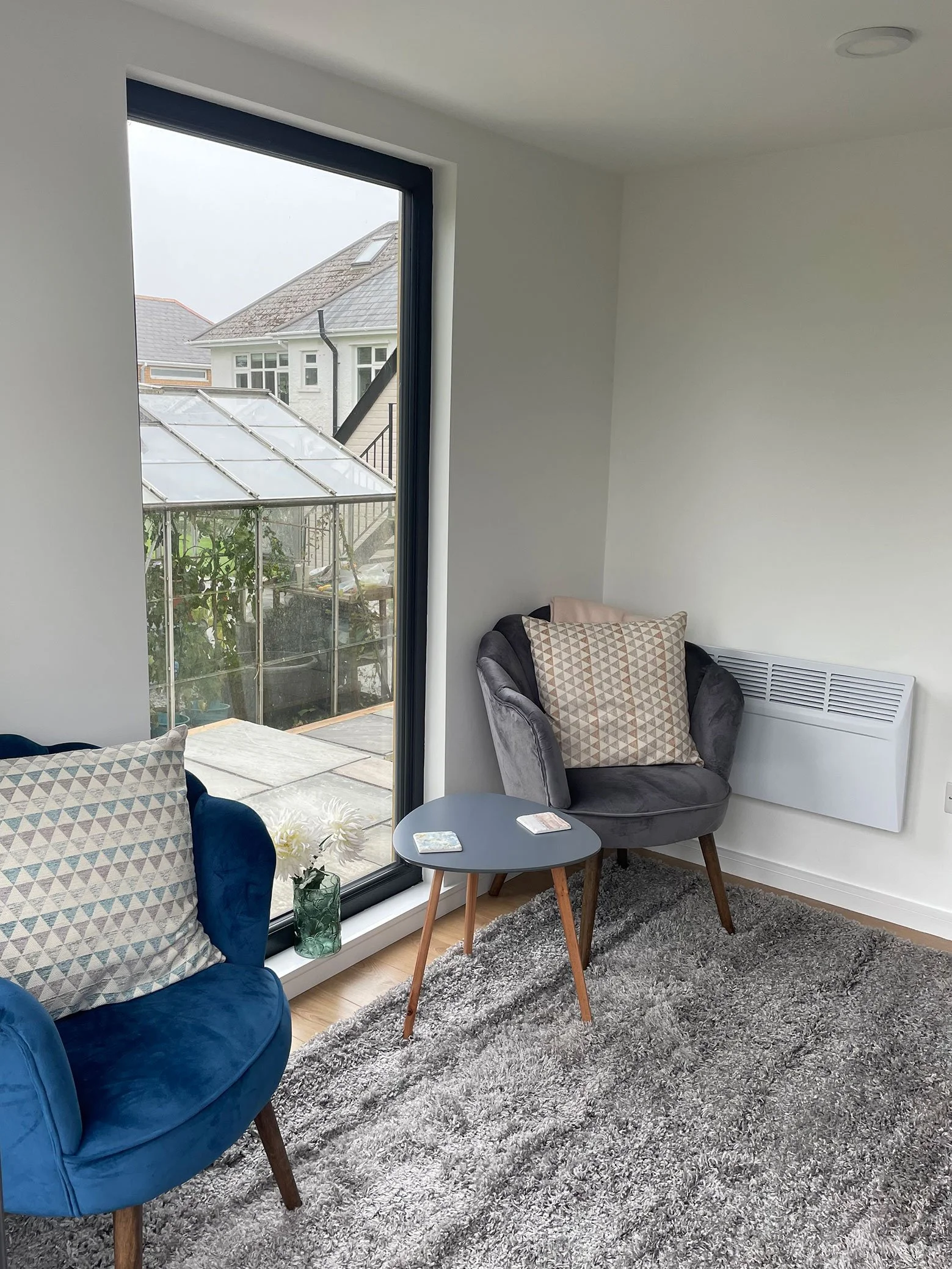  Relaxing outdoor living room with two blue chairs and a view. 