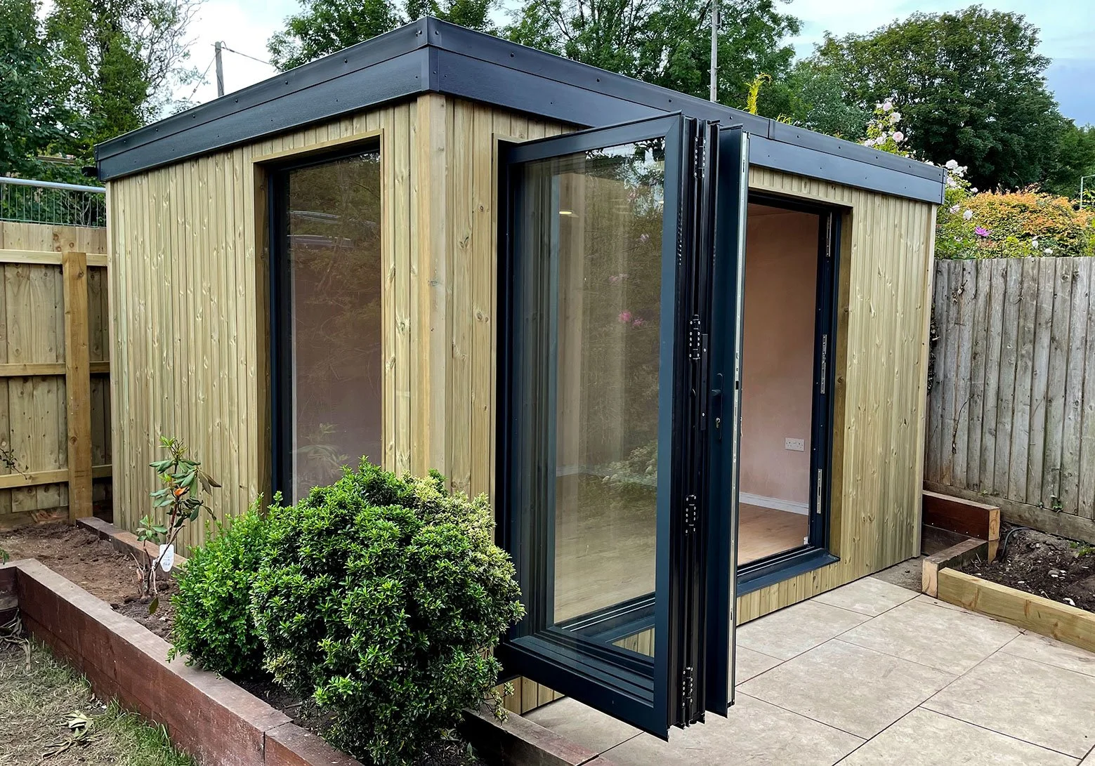  Sleek garden office design with a sliding door. 