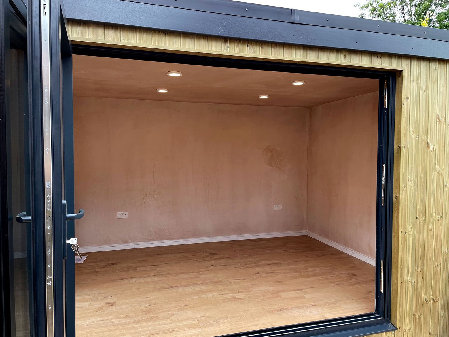  Interior of a room featuring wooden floors and a sliding door. 
